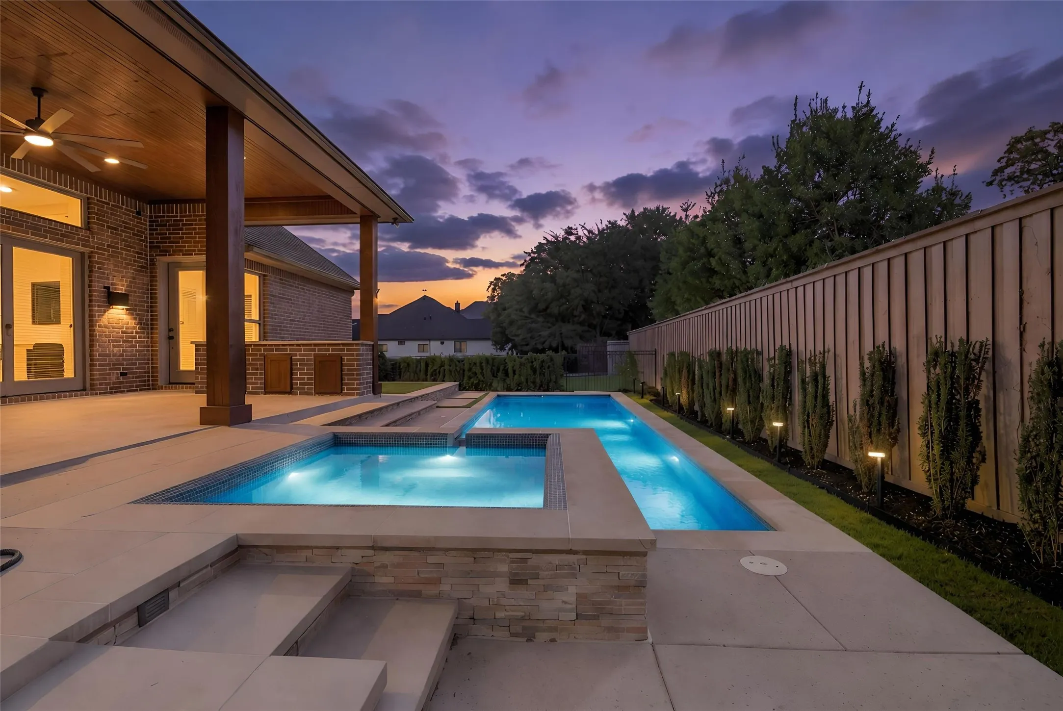 Covered outdoor patio with a wood-finish ceiling and ceiling fan