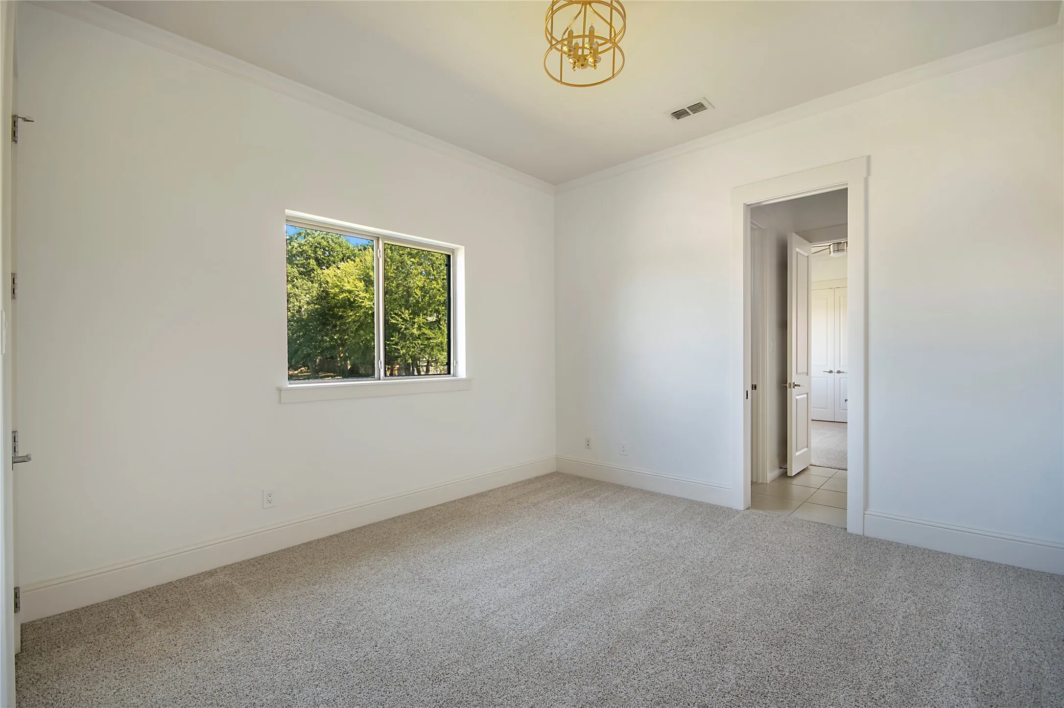Recessed window, crown molding, cased doorway, recessed lighting, and a decorative ceiling fixture