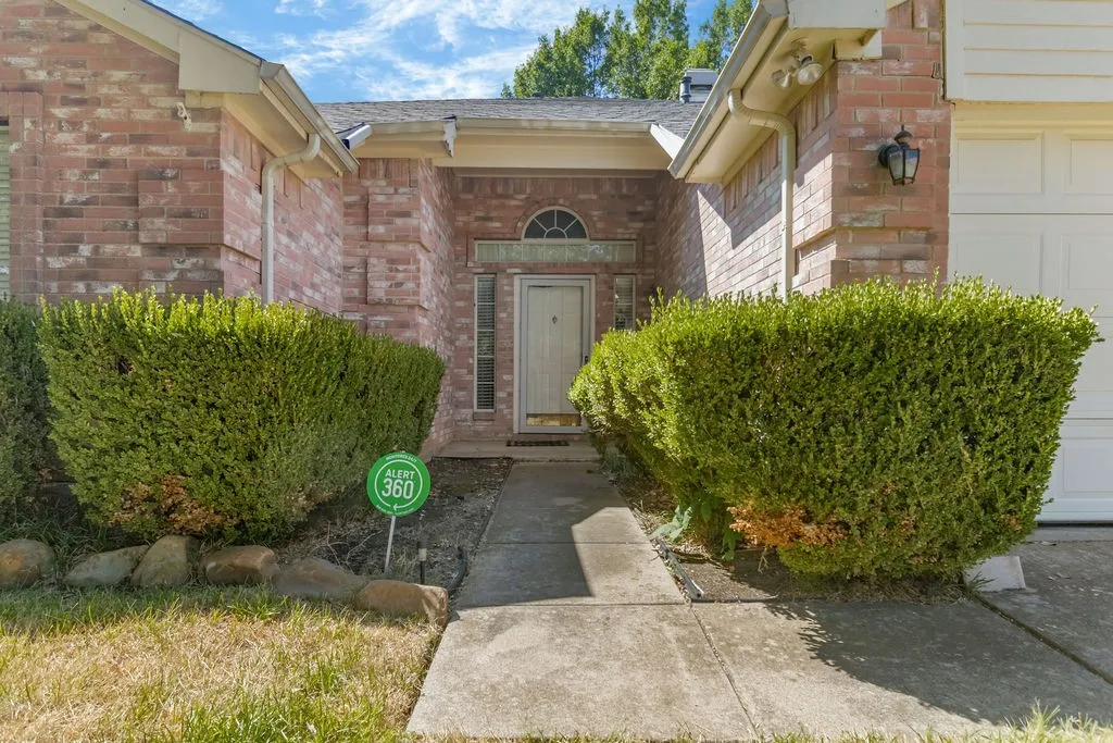 Brick facade with arched transom window above the entry