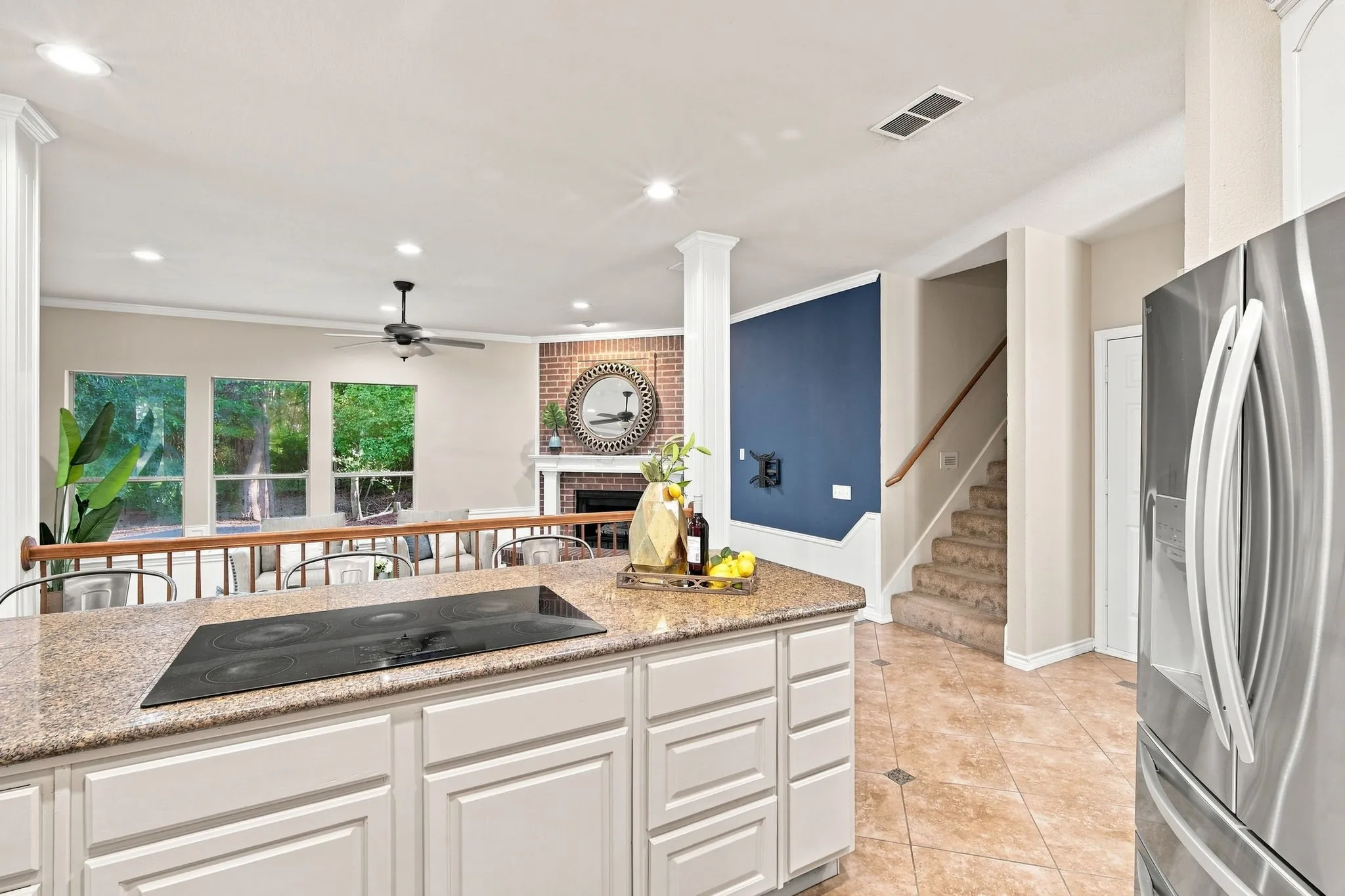 A closer look at the kitchen island, finished with a handsome stone-look countertop and built-in electric cooktop, perfect for entertaining.