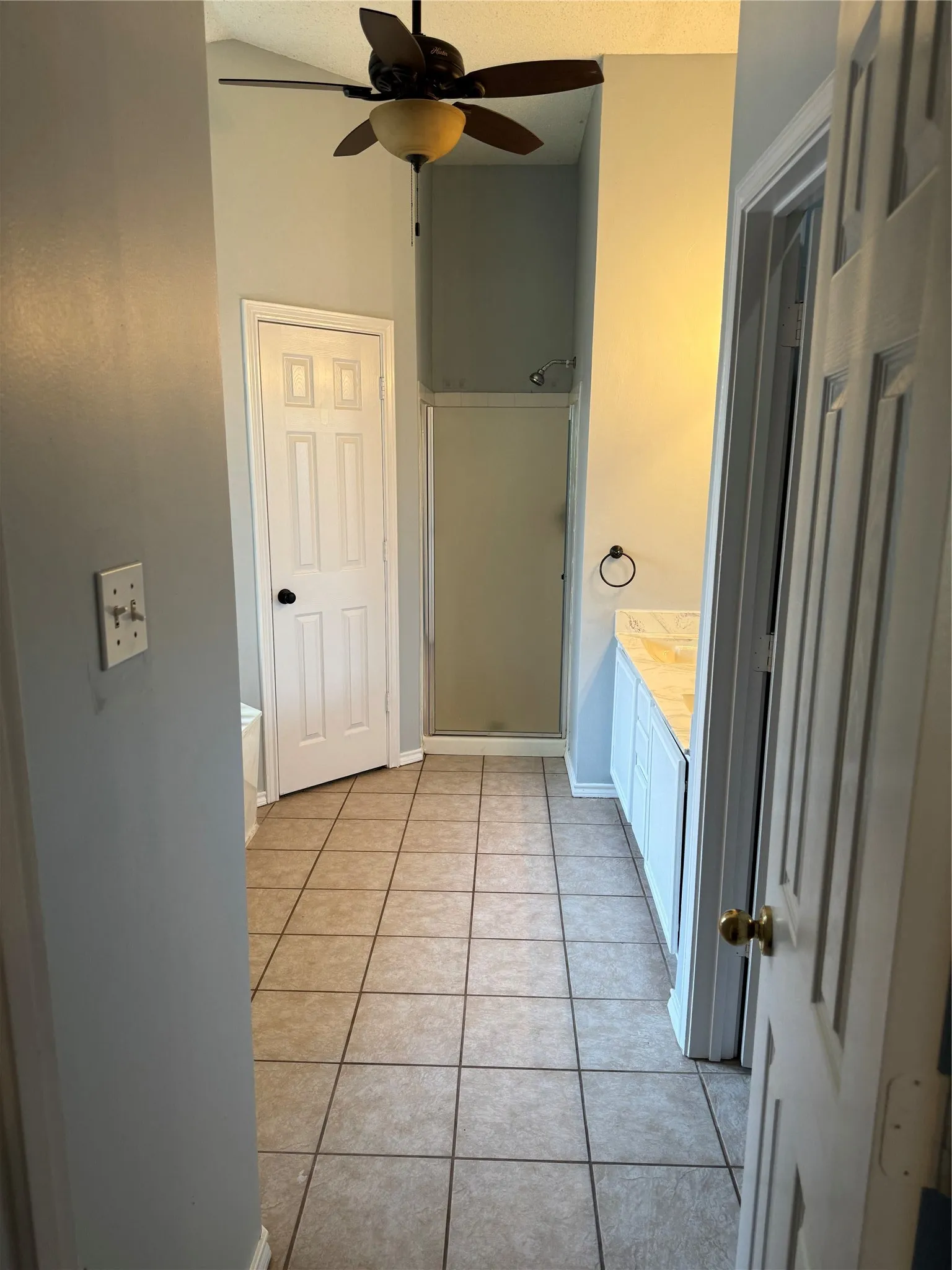 Bathroom with tile floors and ceiling fan