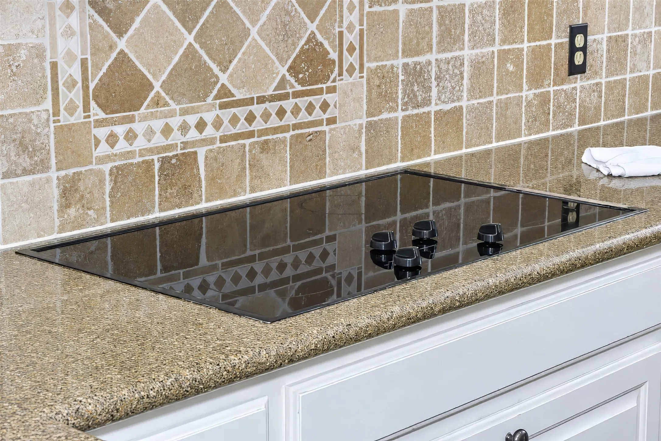 Granite counter tops and a tasteful backsplash complement the premium appliances.