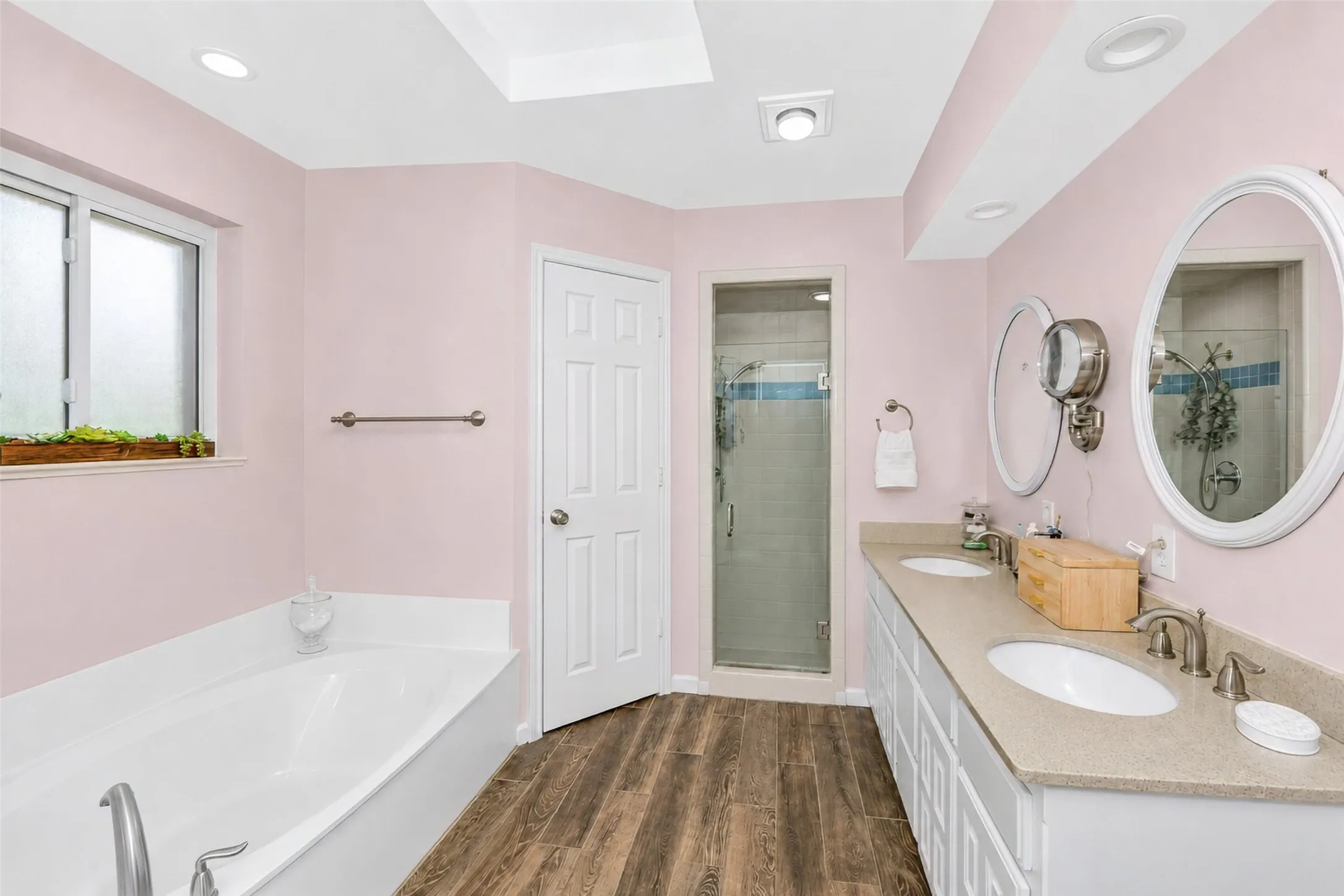 Primary bath features double closets, dual sinks, a garden tub and a separate shower.