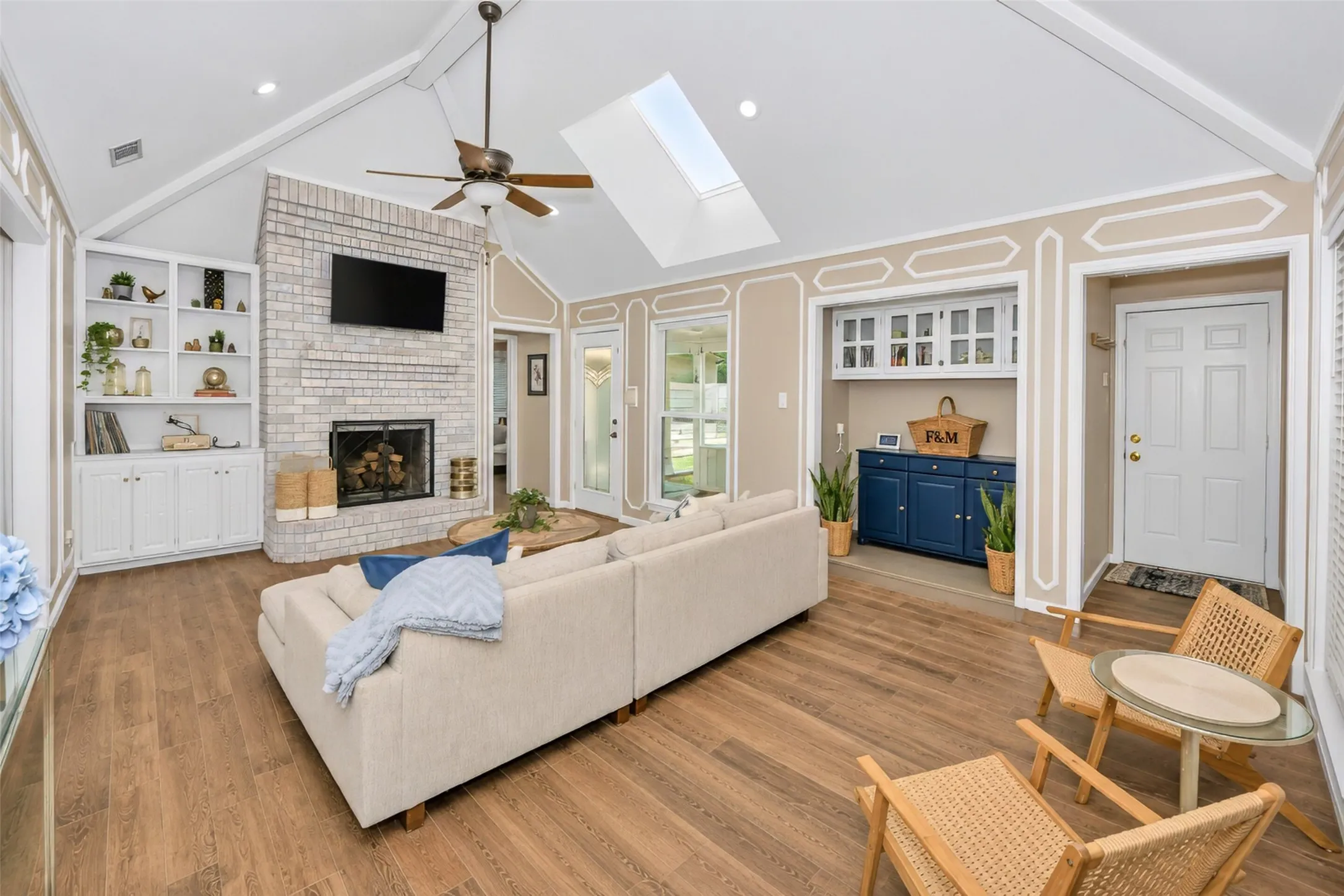 Note the cathedral ceiling, millwork, custom book case  and skylights.