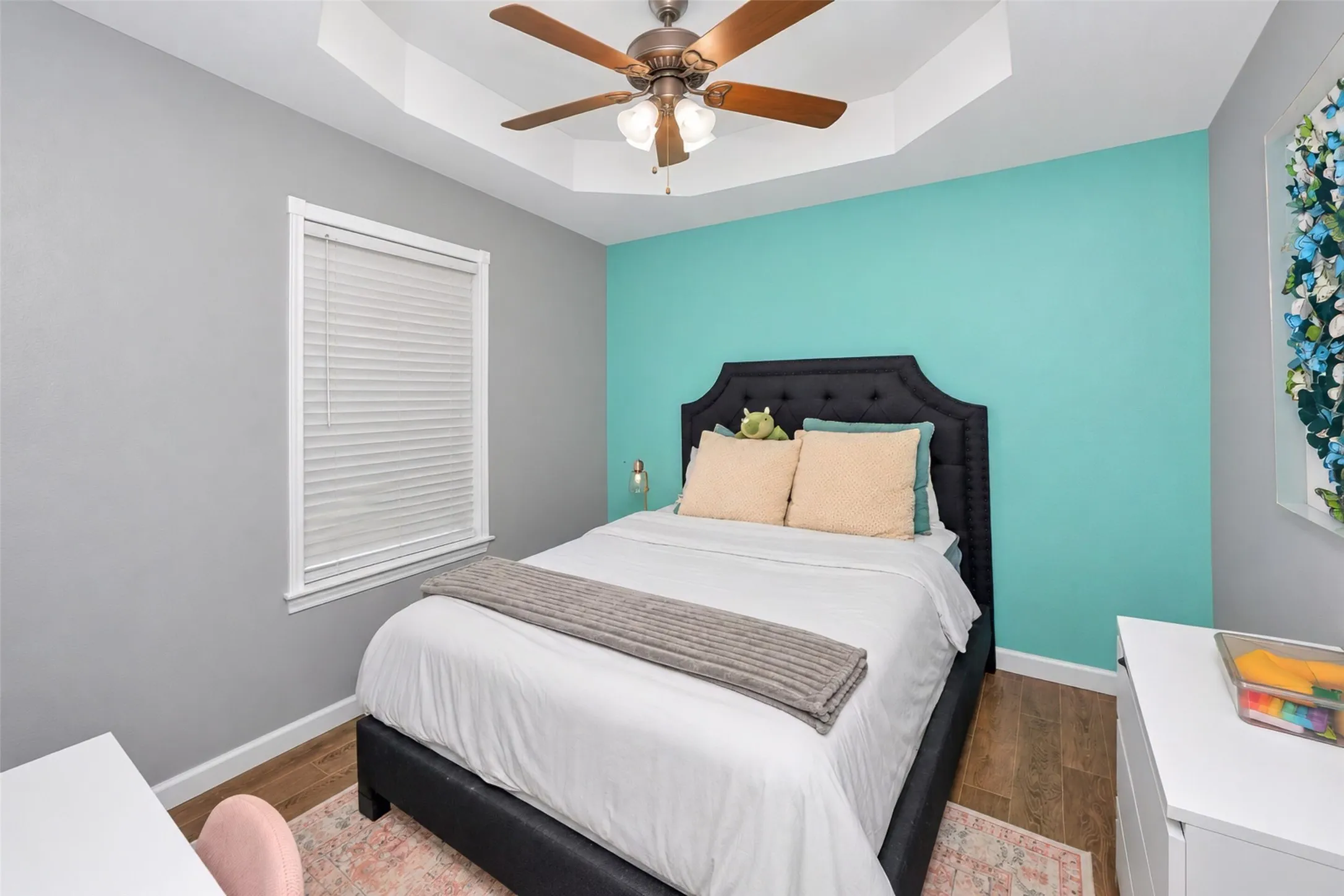 Bedroom 3 features a colorful accent wall.
