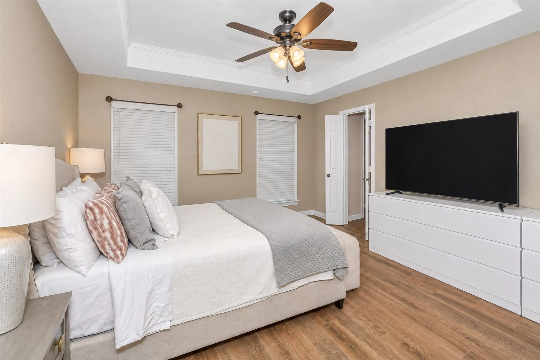 Gorgeous primary bedroom featuring a trayed ceiling and ensuite bath.