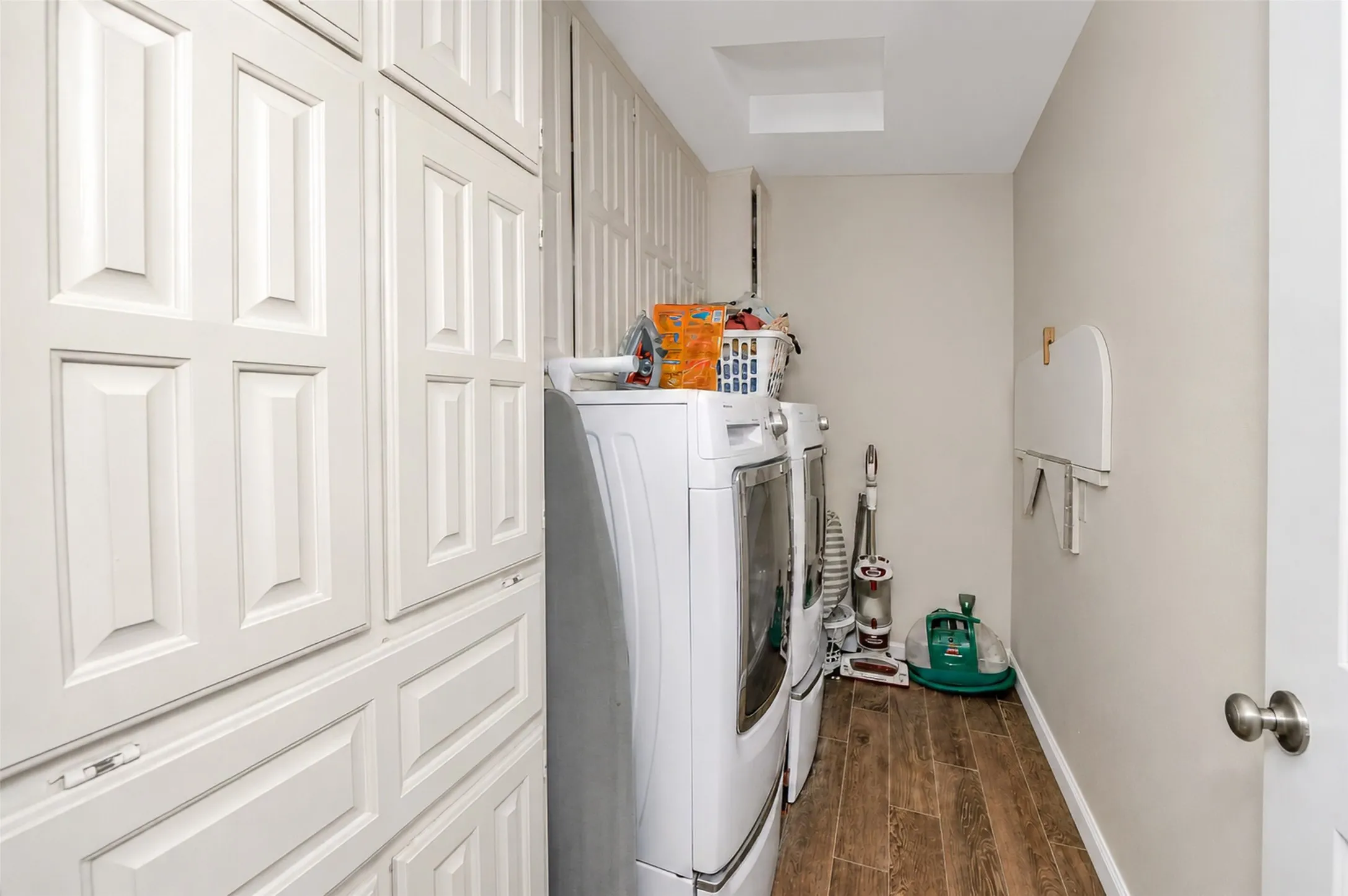 Large laundry room with plenty of built in storage.