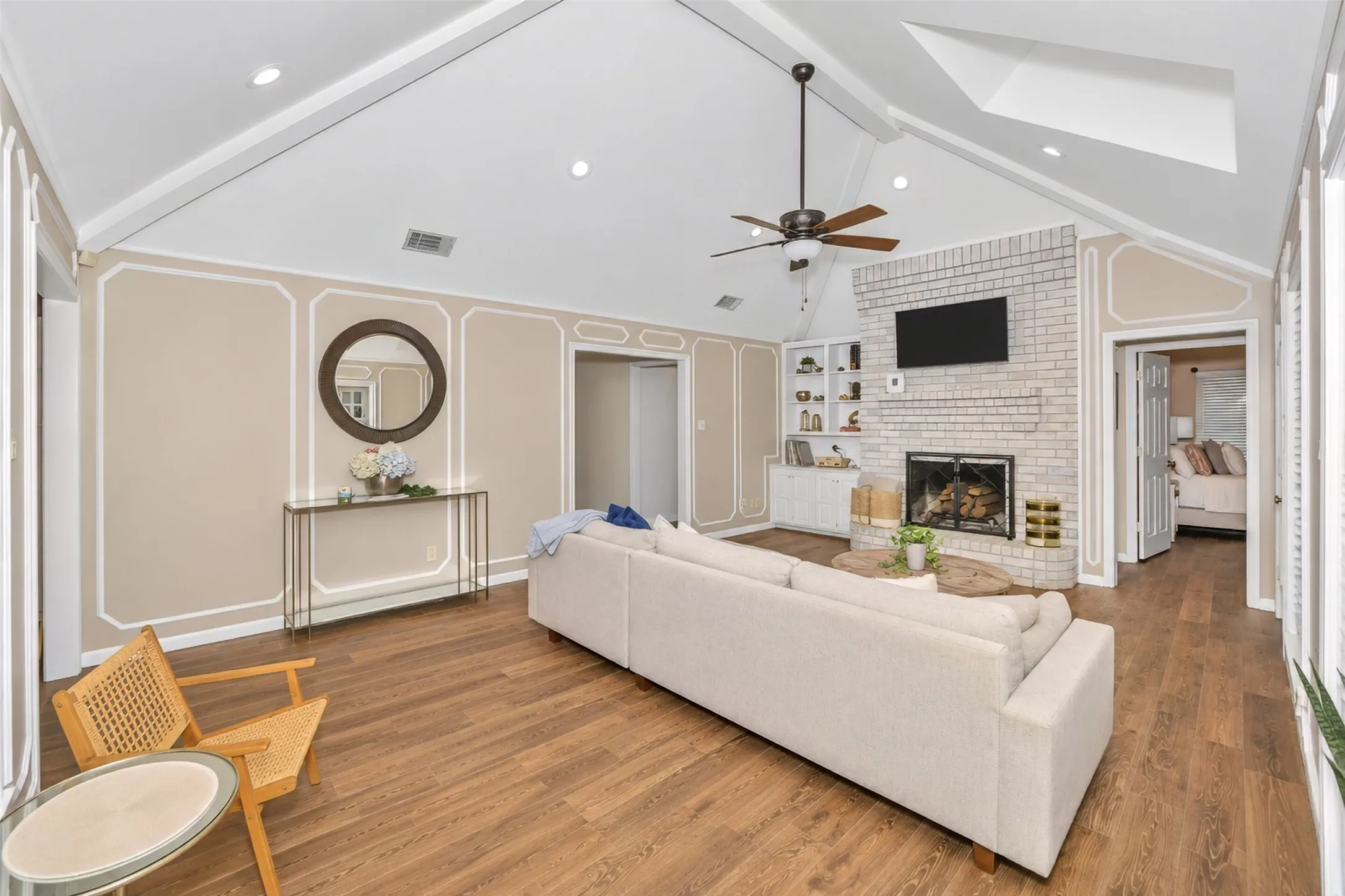 A massive brick wood burning fireplace is the center focus of this impressive room.