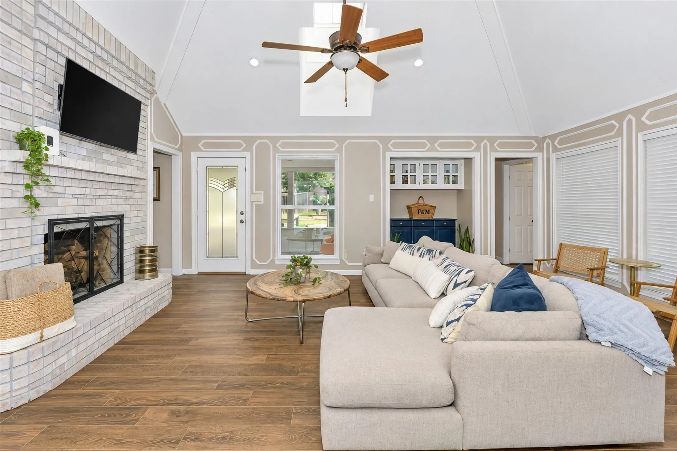 The great room enjoys views out to the court yard and pool.