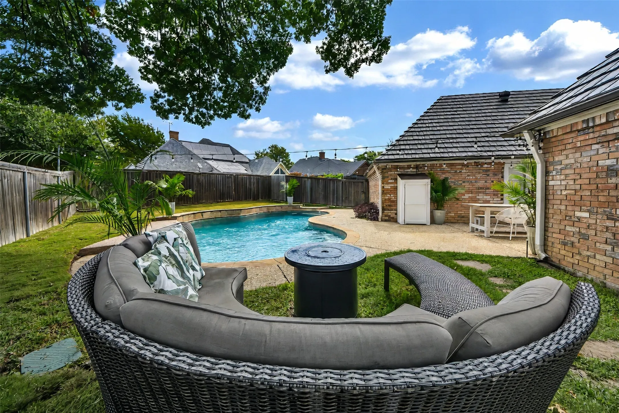 This is a dream back yard...a mature tree offers a lovely spot to relax overlooking the pool.