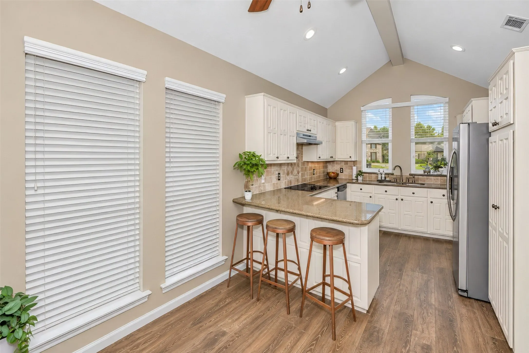 A cozy breakfast area is part of the kitchen area next to the breakfast bar.