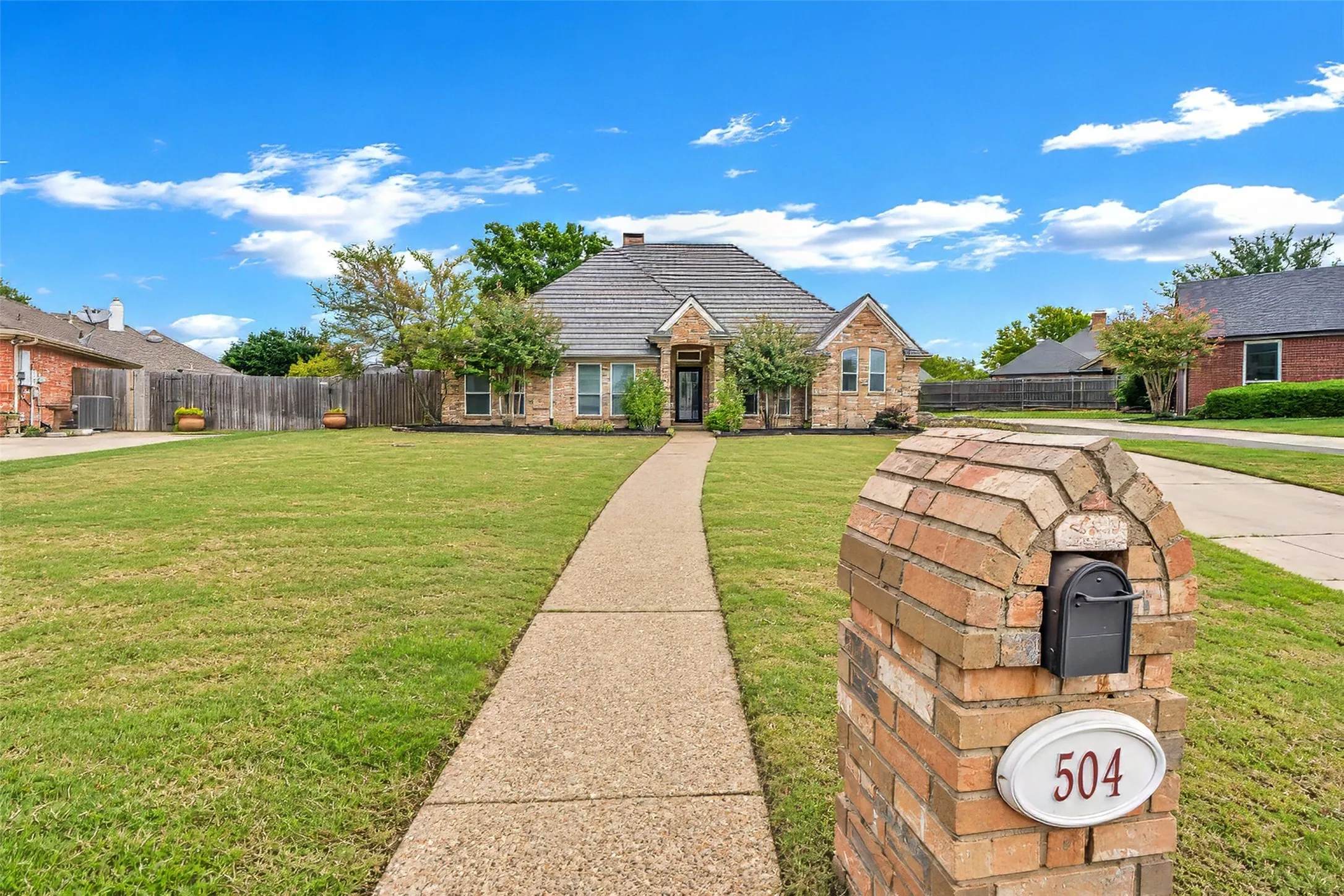 Set well back from the cul-de-sac, this home has curb appeal plus! Note the metal roofing and custom sized windows.
