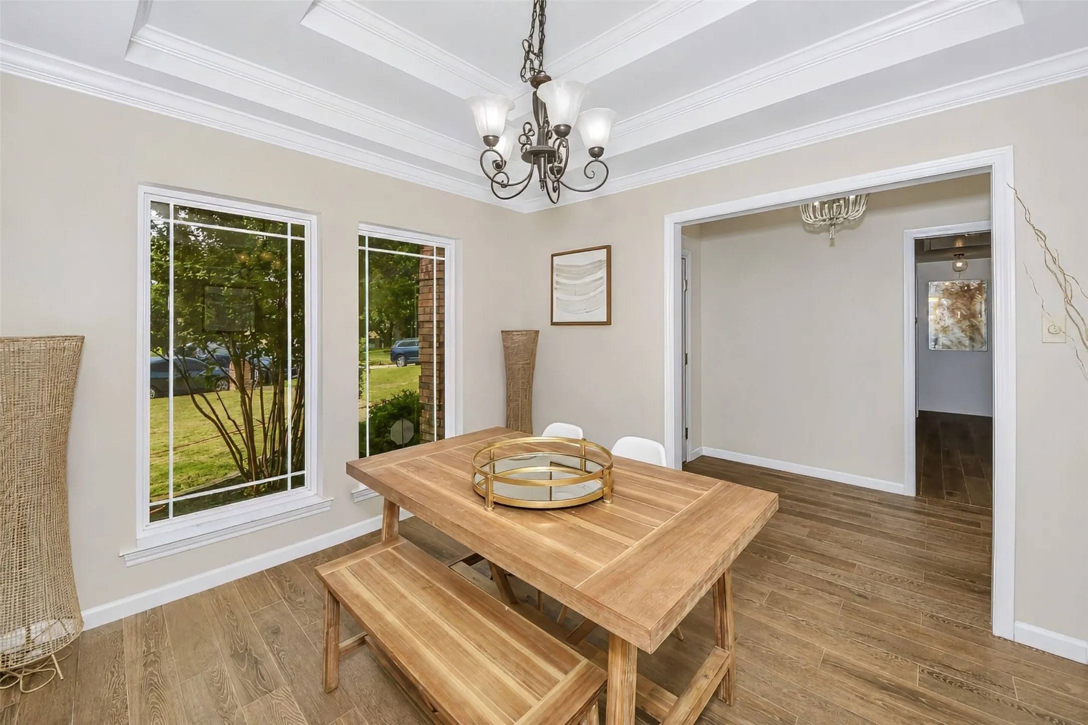 Dining room features trayed ceiling and custom millwork.