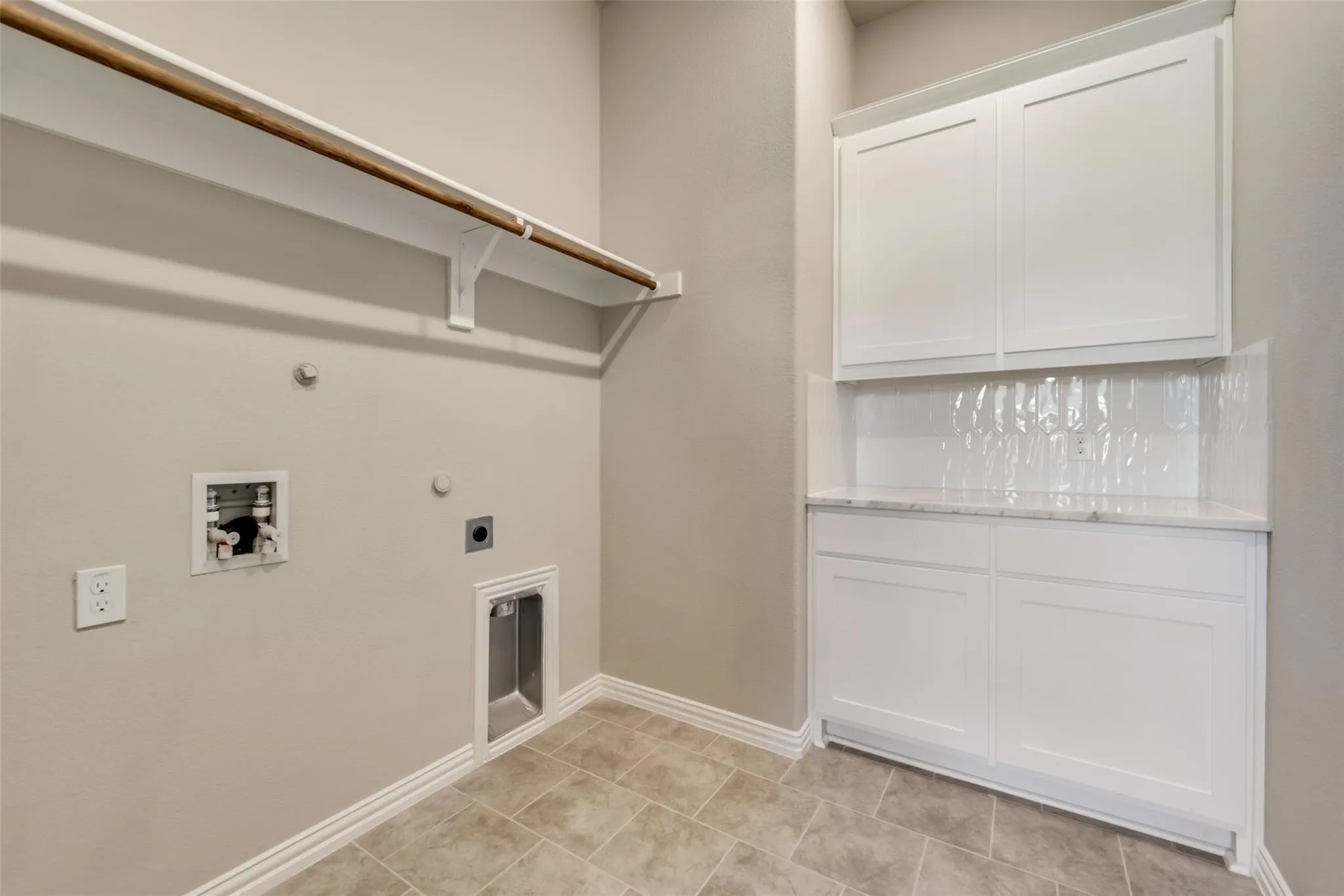 White shaker-style cabinetry with a countertop, white subway tile backsplash, and tile flooring