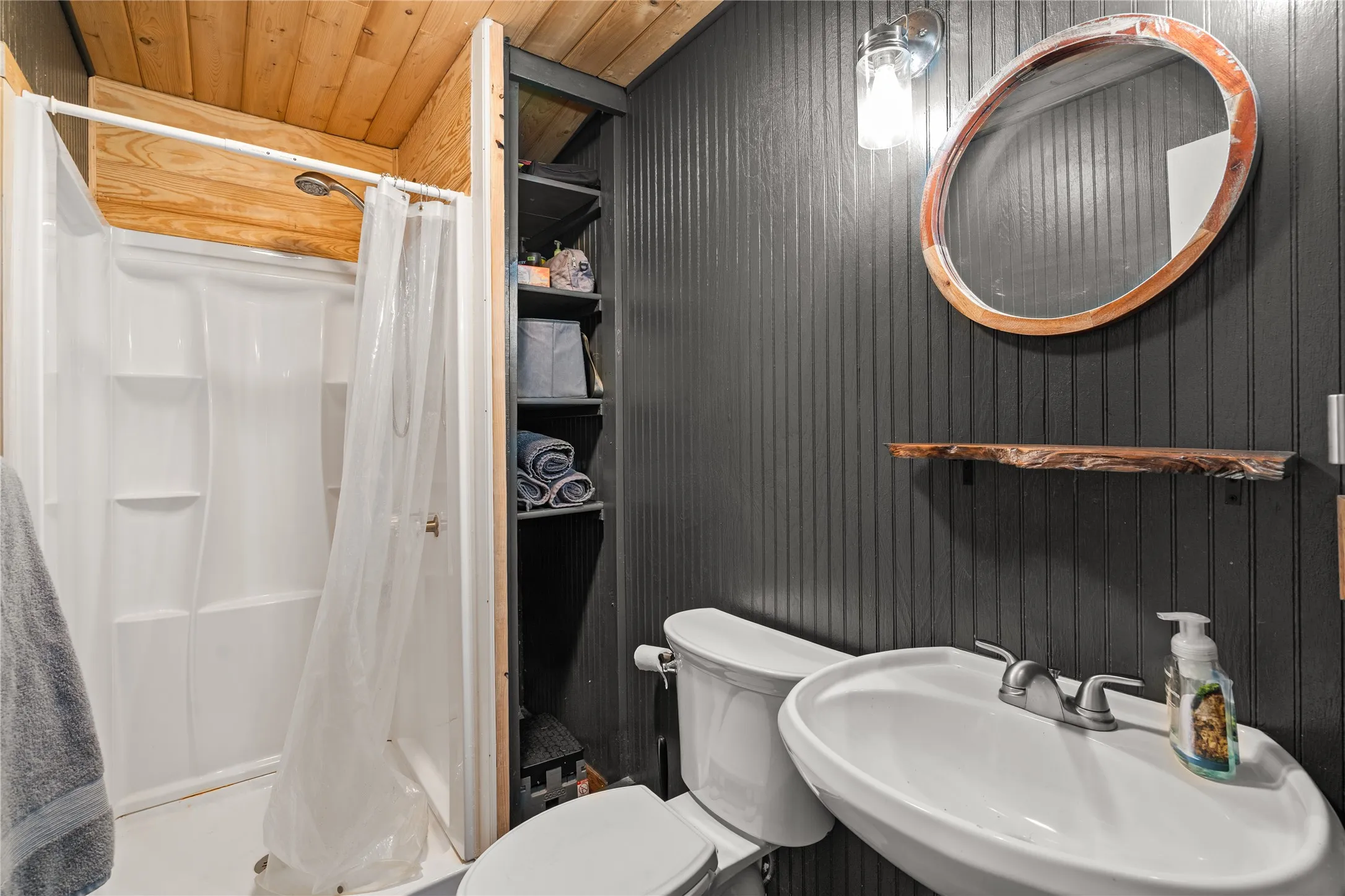 White shower enclosure with a chrome shower head