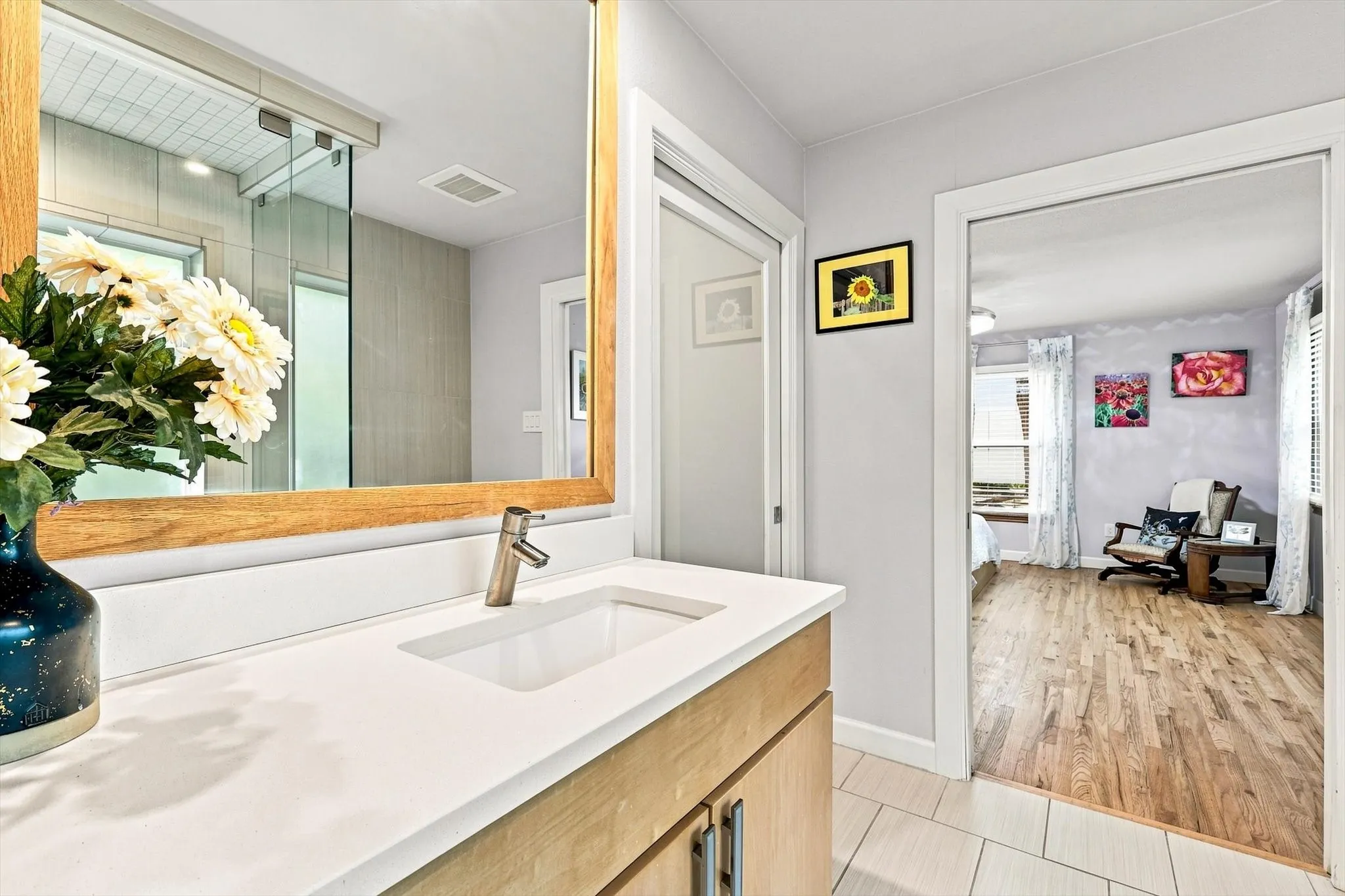 Ensuite bath opens to primary bedroom and walk-in closet via pocket doors. Doors disappear when open.