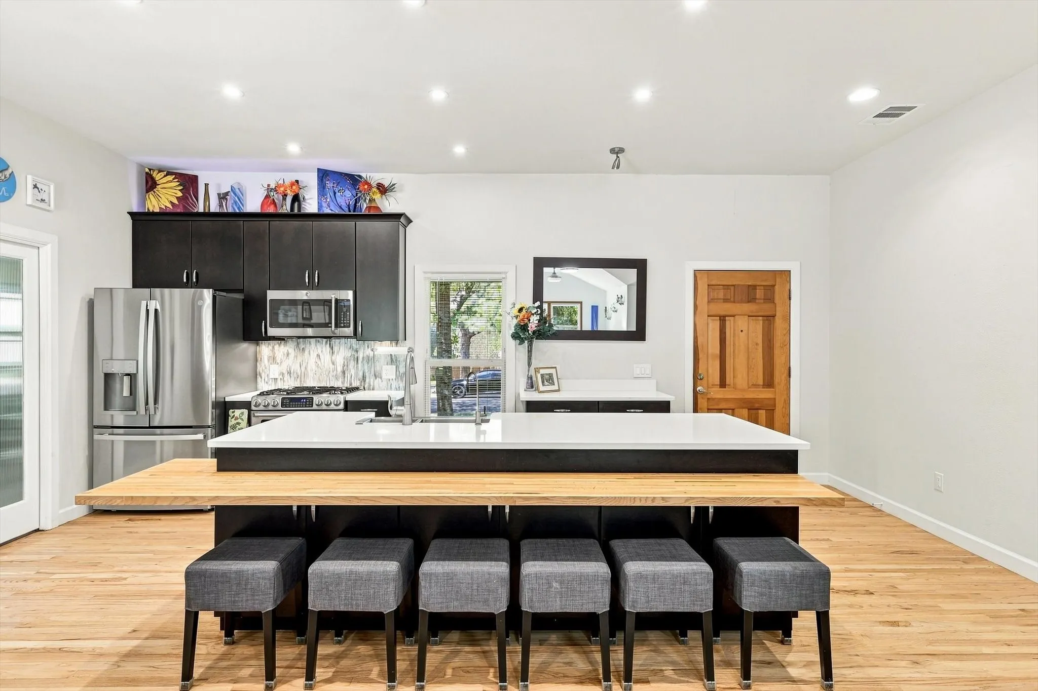 Chef's delight kitchen featuring a large central island that can accommodate multiple bar seating.
