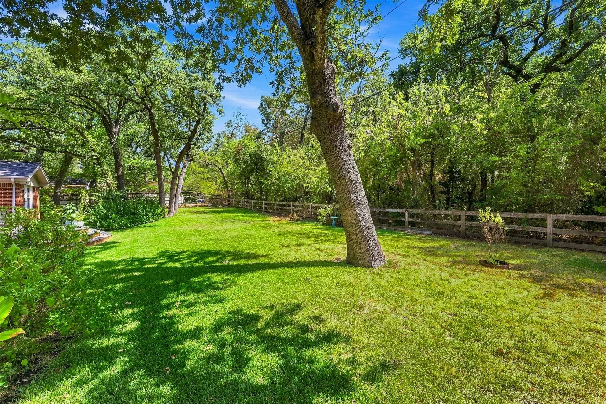 Expansive grassy area with mature trees and wonderful landscaping. Home backs to a highly wooded 2 acre property.