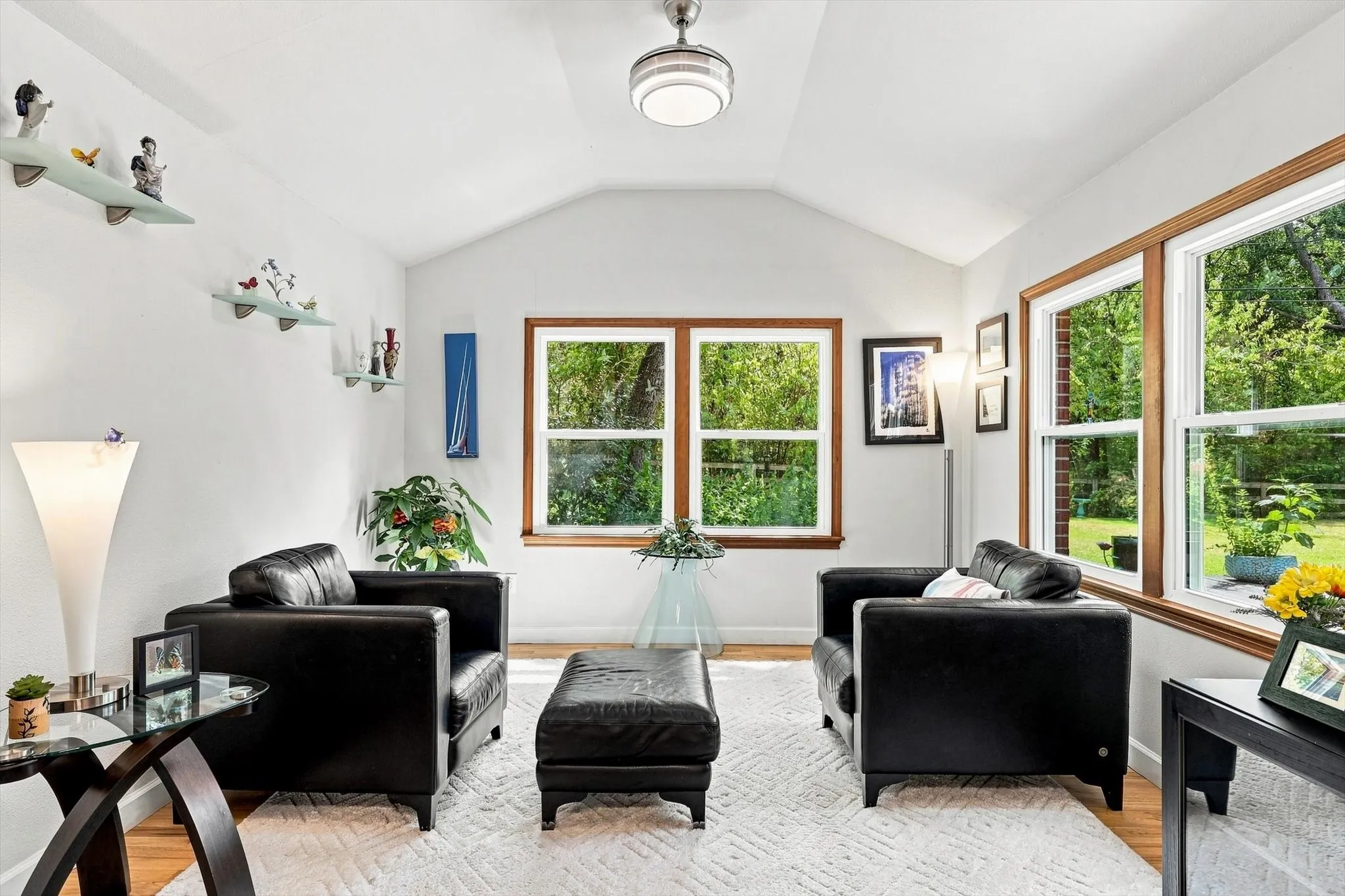 Additional seating area in off of the living room overlooks the lush backyard.