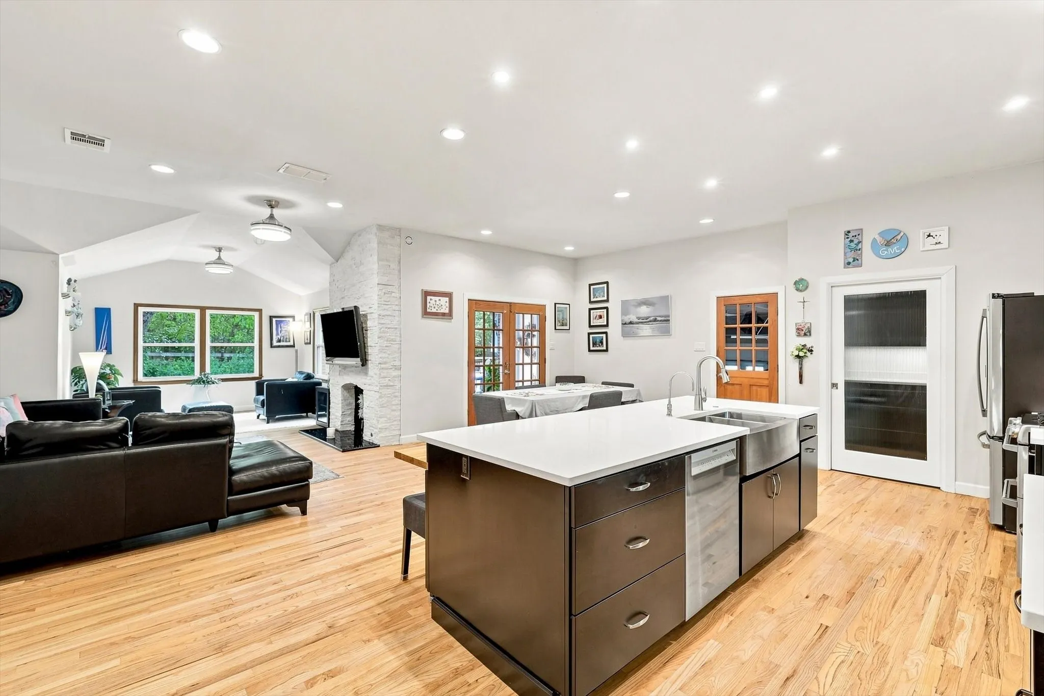 This home features a spacious kitchen with an oversized island, undermount sink with touchless faucet, and stainless steel appliances.