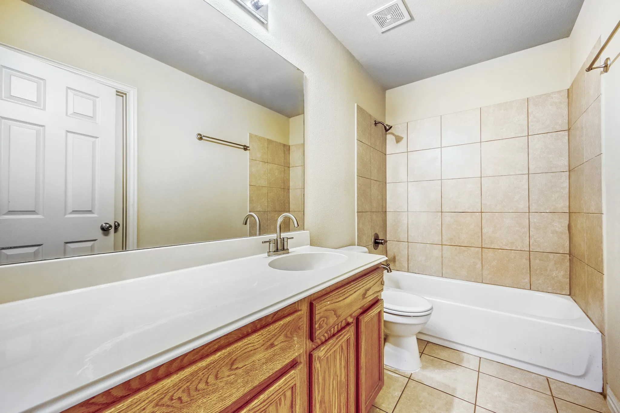 Wood-finish vanity with an integrated sink and brushed nickel faucet