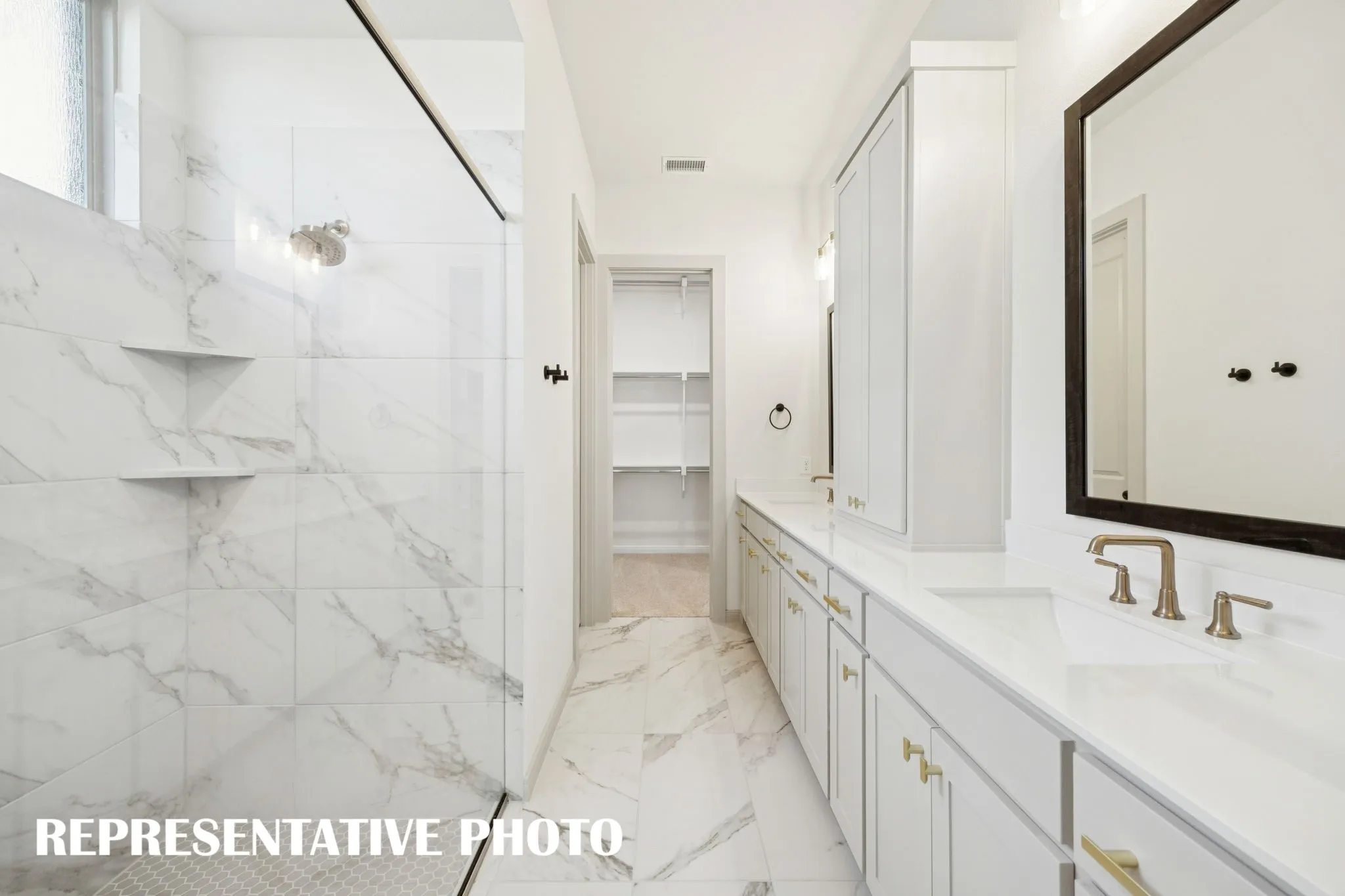 With a spacious walk in shower and wonderful closet featuring seasonal hanging space, this owner's bath offers everything you have been searching for!  REPRESENTATIVE PHOTO