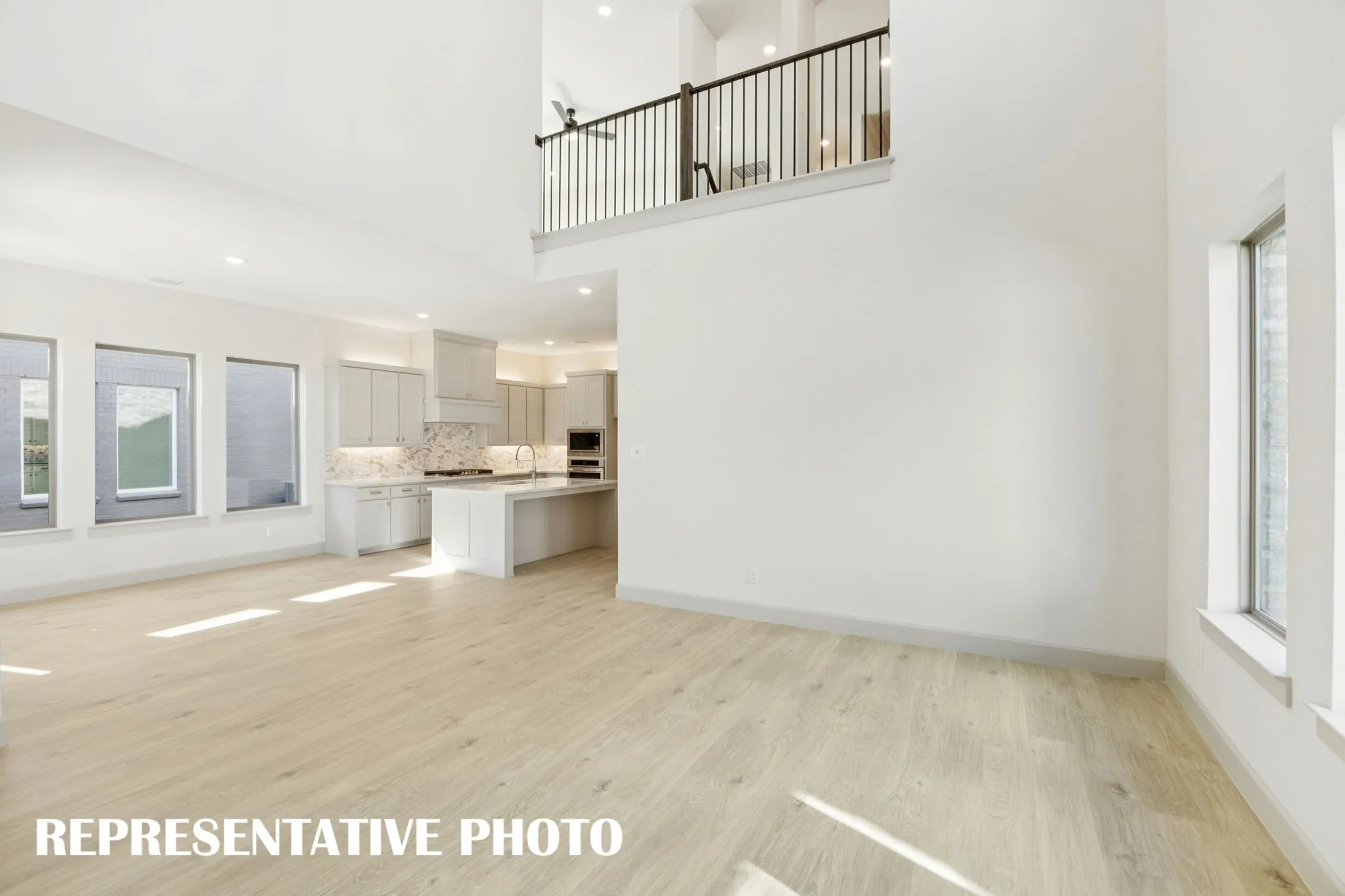 The game room overlooks your new family room creating dual entertainment levels.  REPRESENTATIVE PHOTO