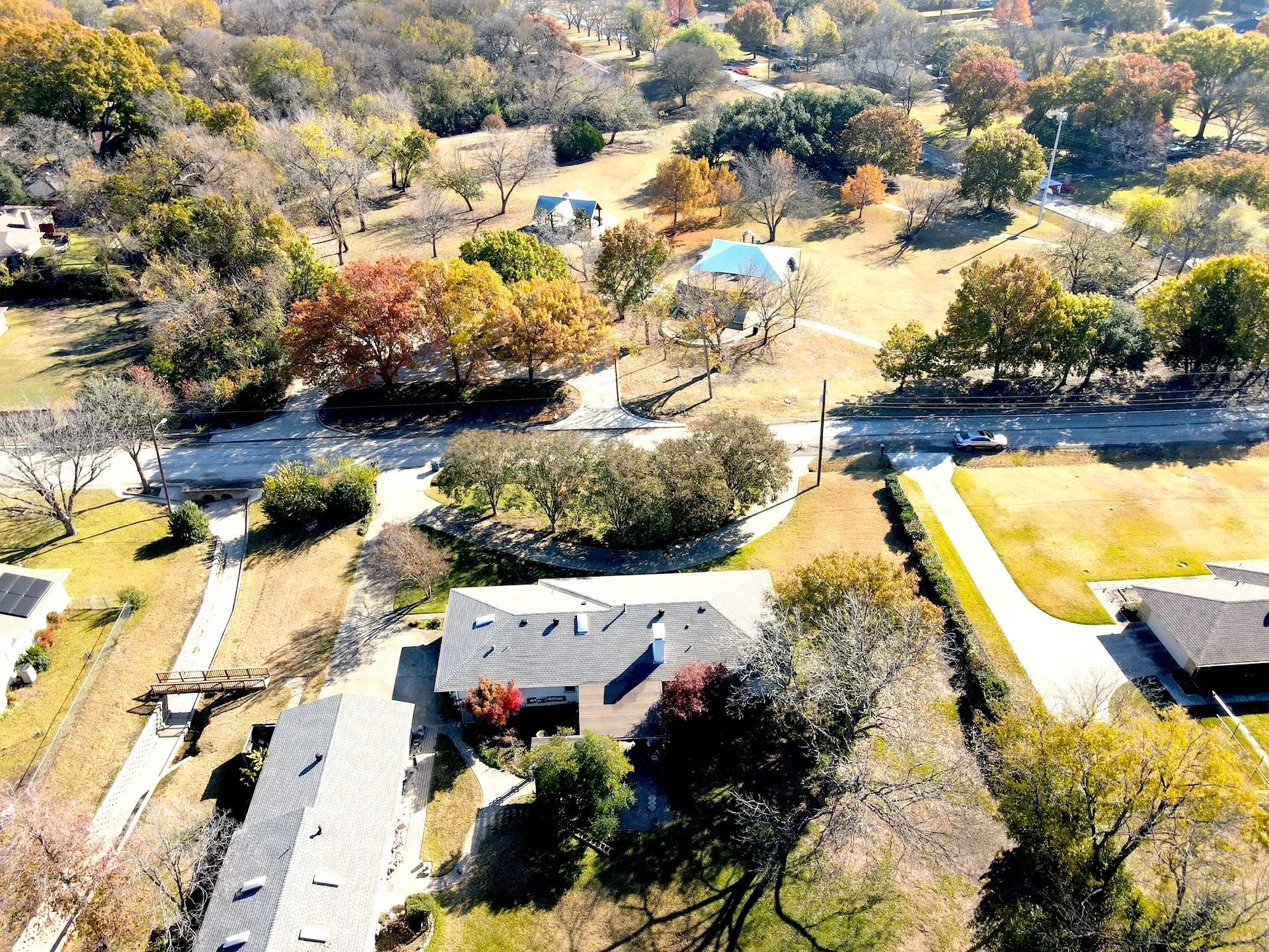 Aerial perspective showcasing residential properties within a tree-lined community