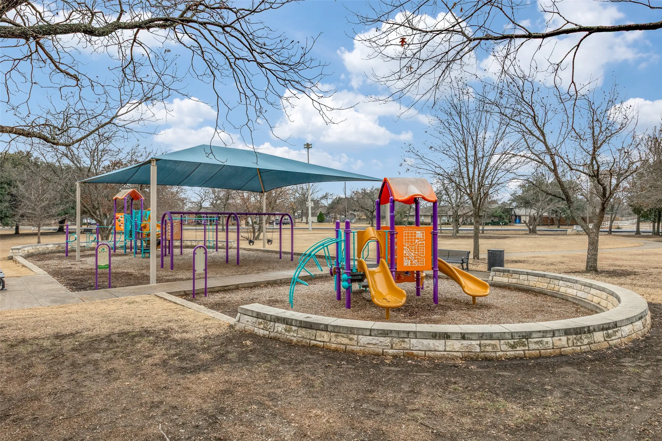 Playground featuring multiple slides, swing sets, and climbing structures