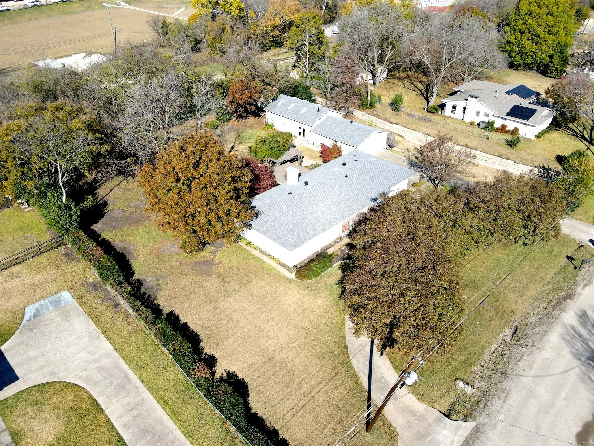 Expansive lot with mature trees and a long driveway