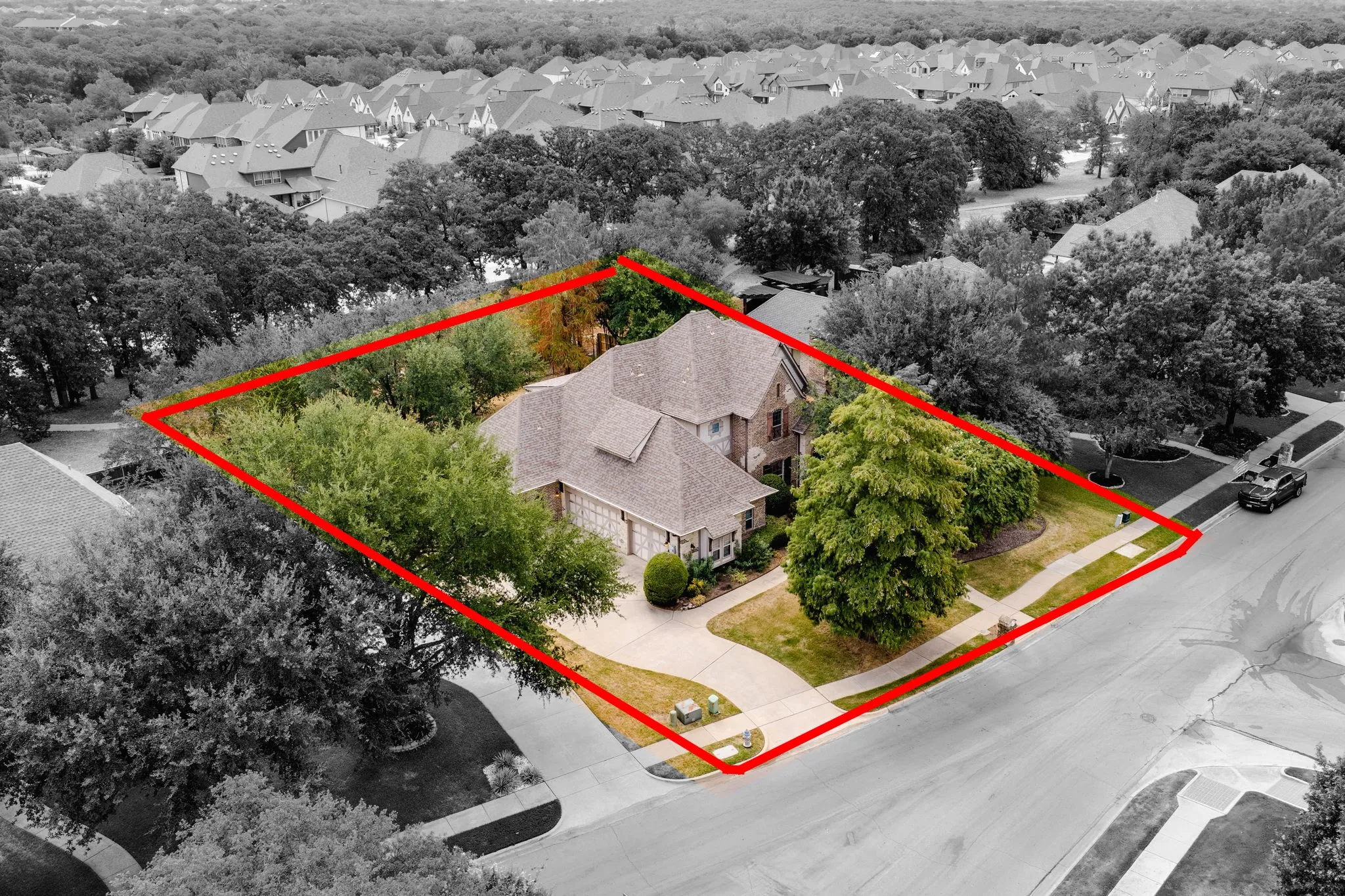 Traditional-style residence with a brick exterior, gabled roofline, and attached two-car garage