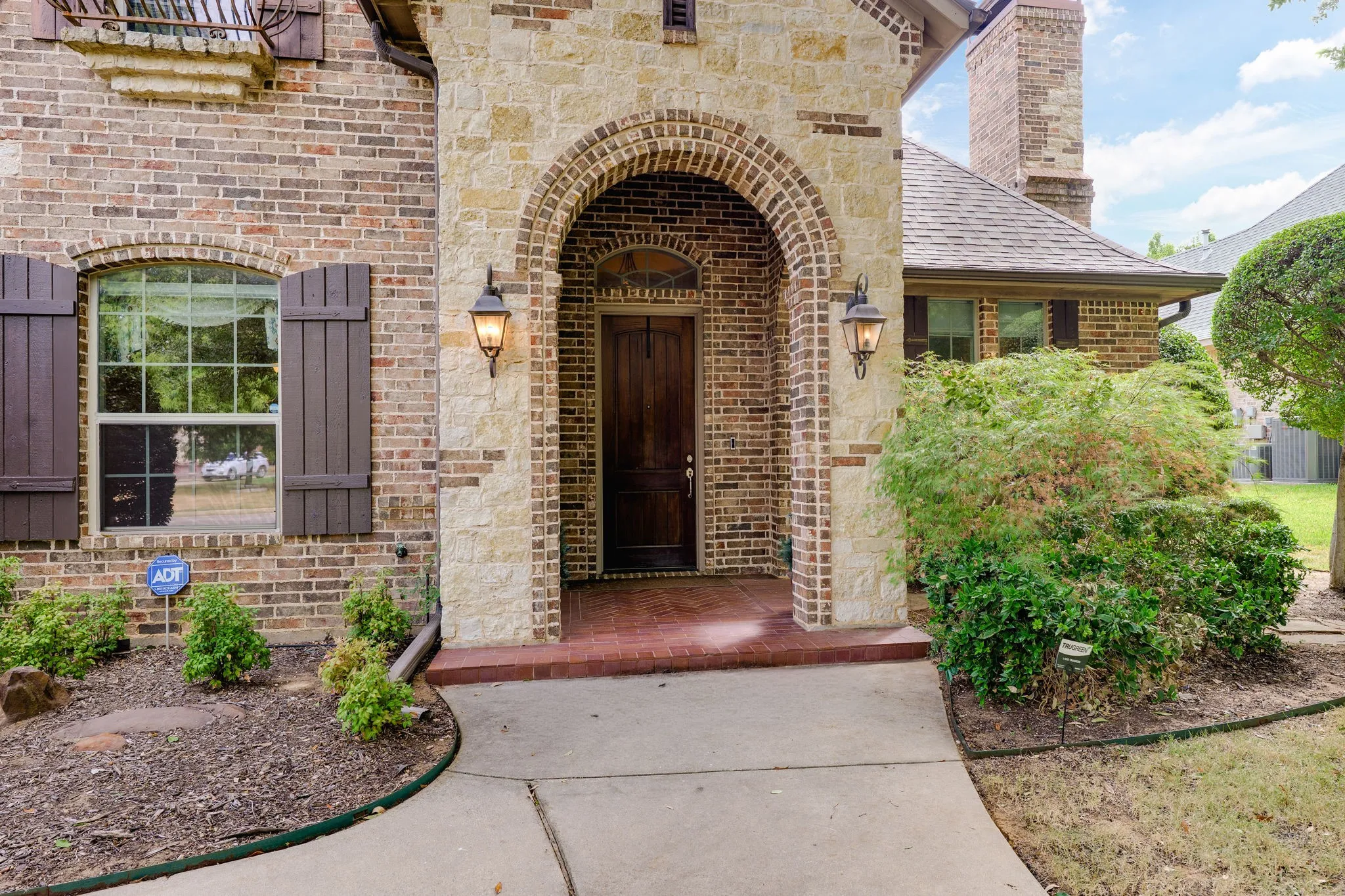 Brick and stone exterior with an arched entryway