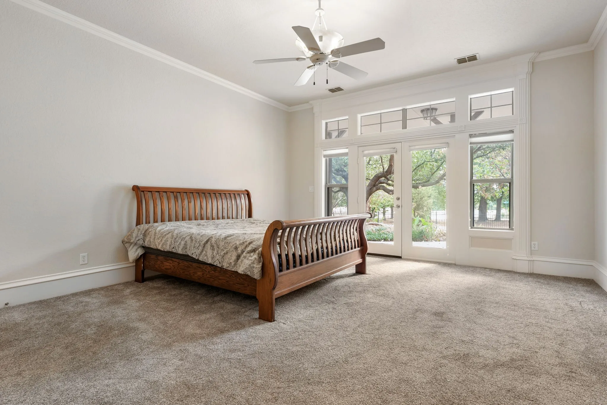 French doors with transom windows, recessed lighting, crown molding, ceiling fan, and carpeted flooring