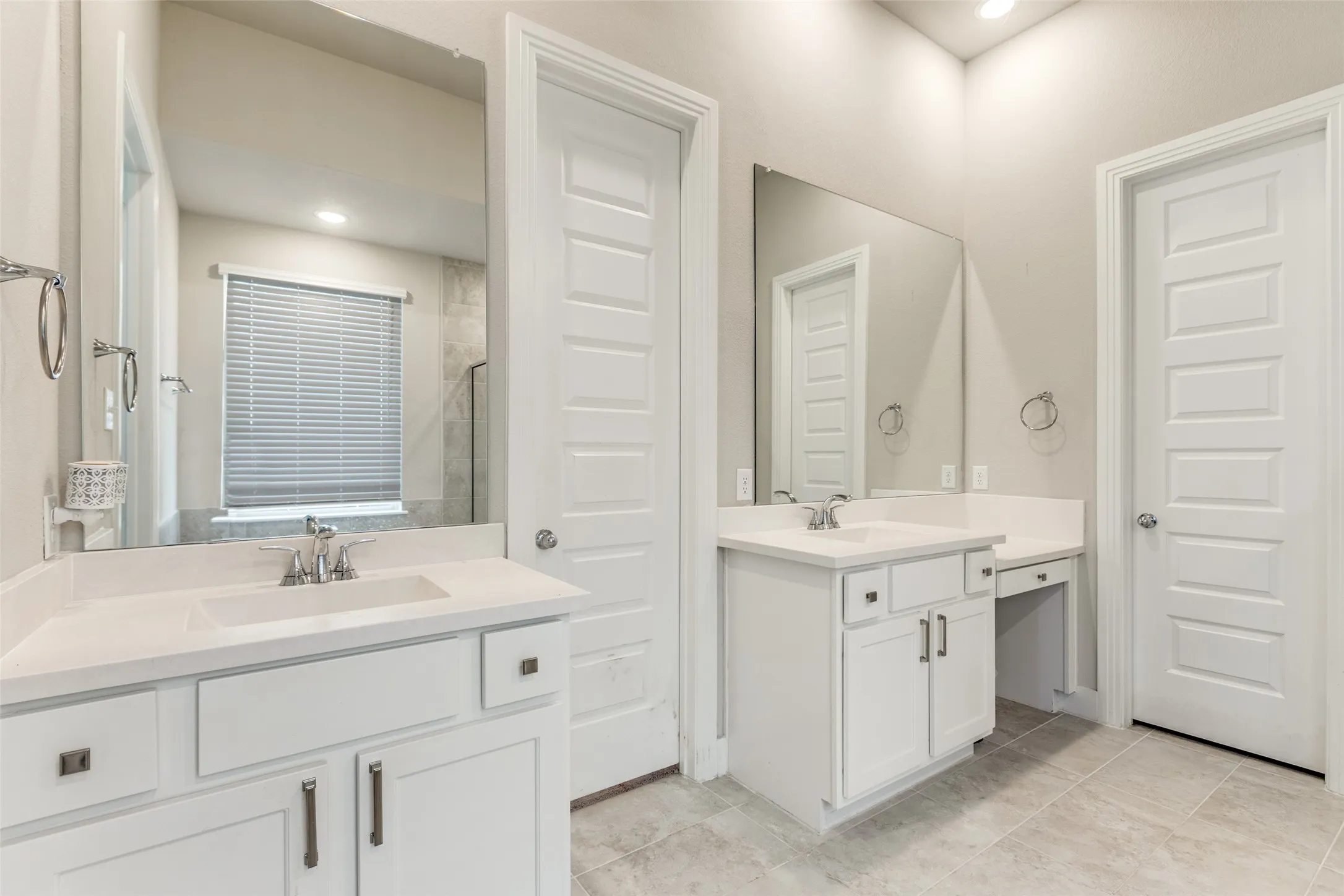 Full bath featuring two vanities, recessed lighting, and light tile patterned flooring
