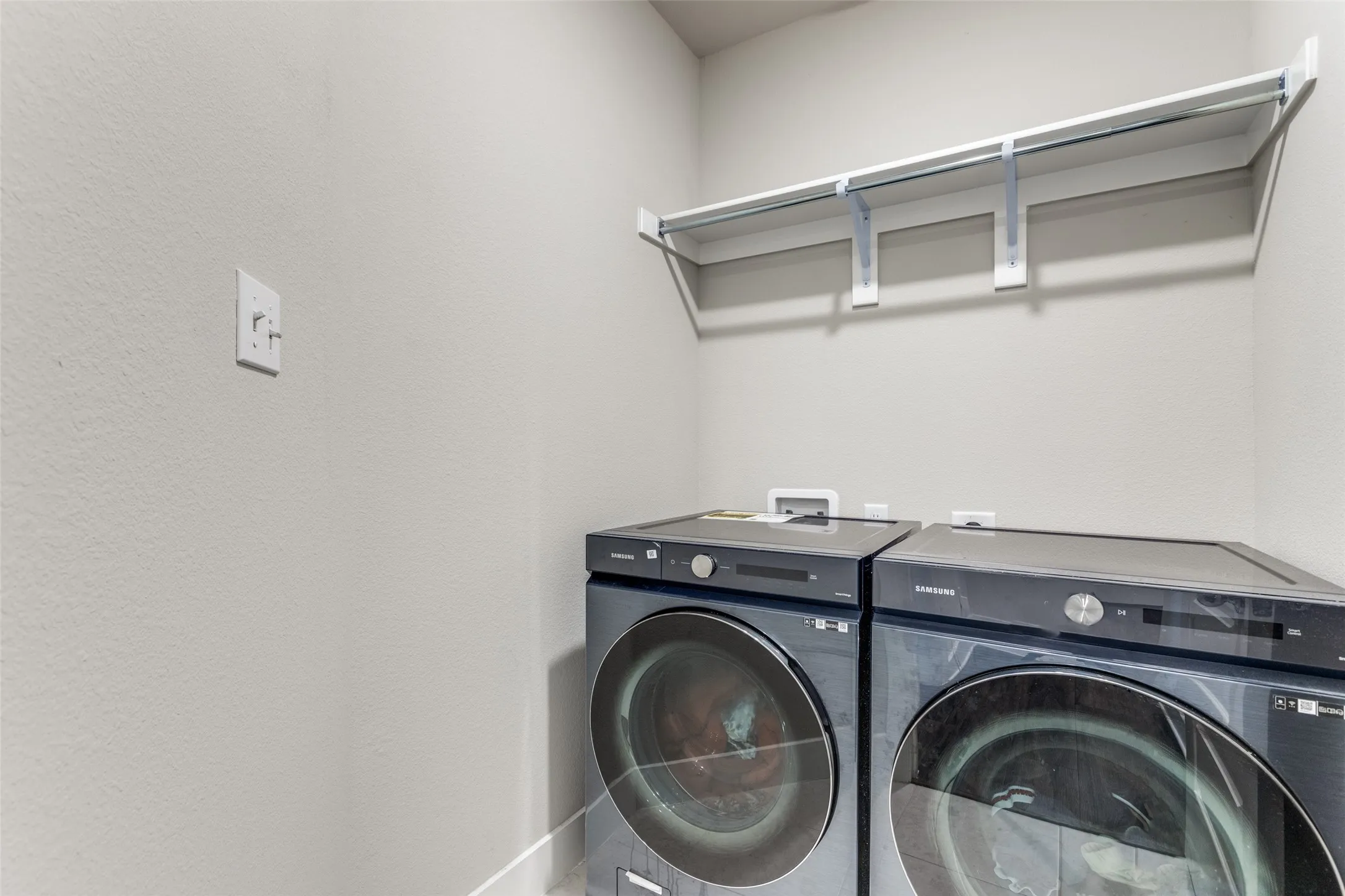 Laundry room featuring baseboards and washer and dryer