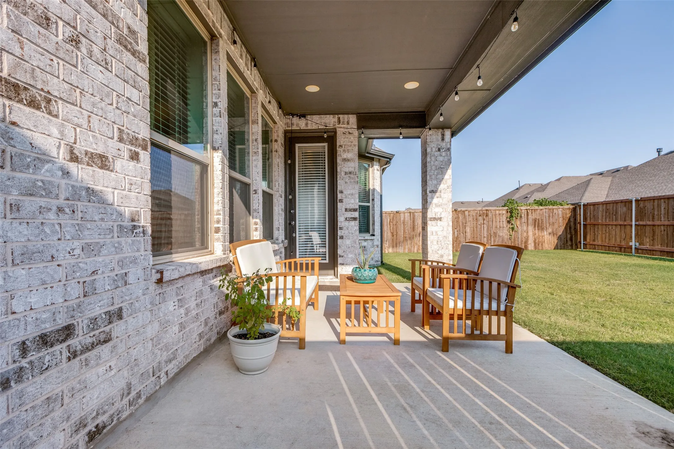 Fenced backyard with a patio area