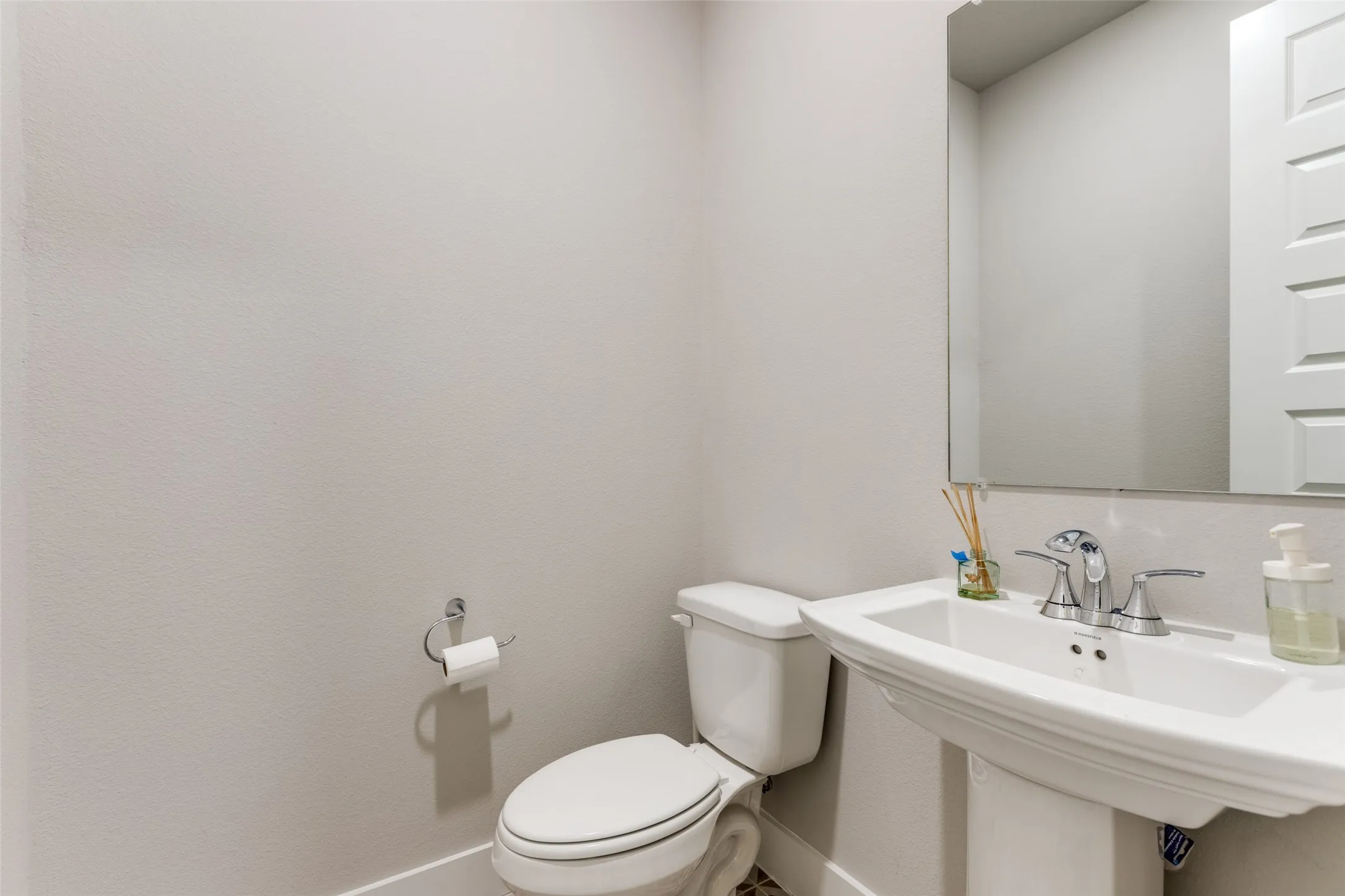Half Bathroom featuring toilet and baseboards