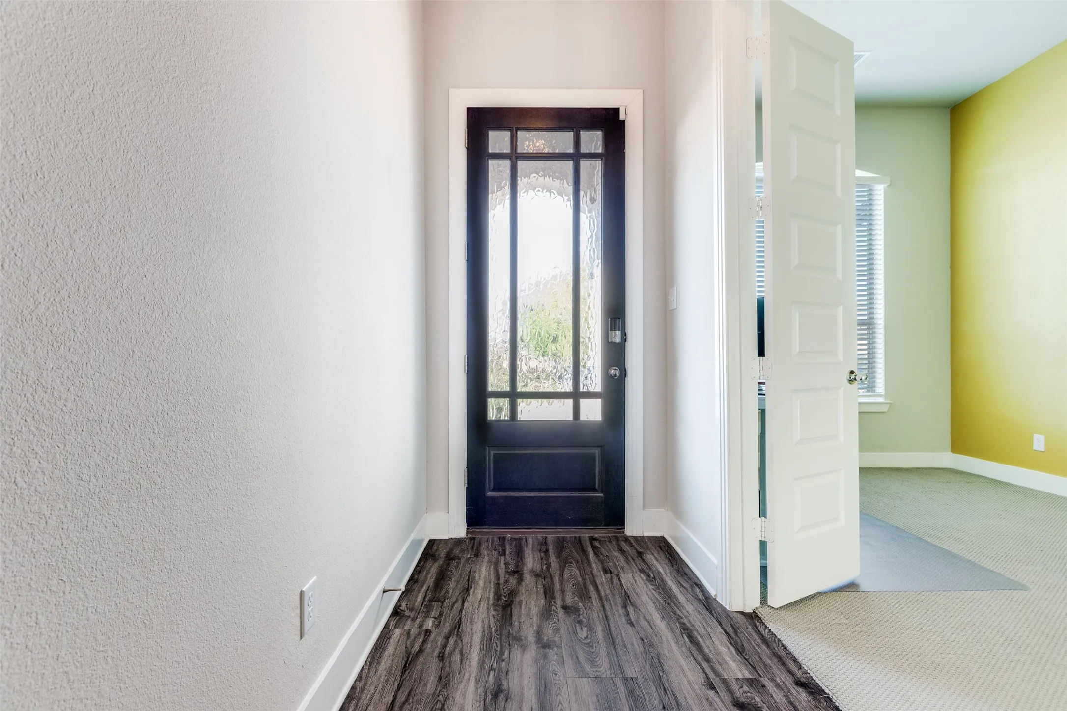 Entryway featuring healthy amount of natural light and dark wood finished floors