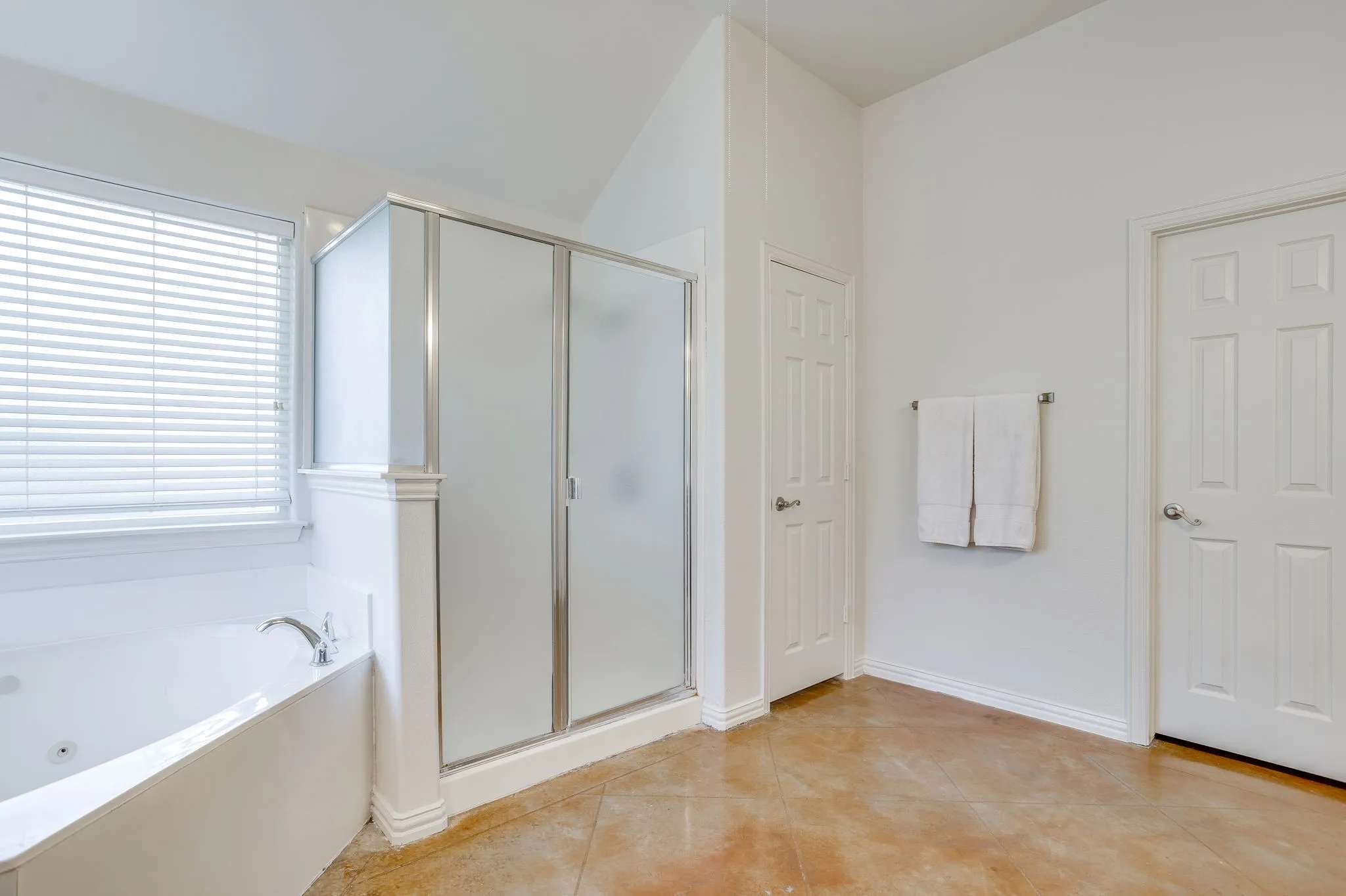 White soaking tub with deck-mounted faucet