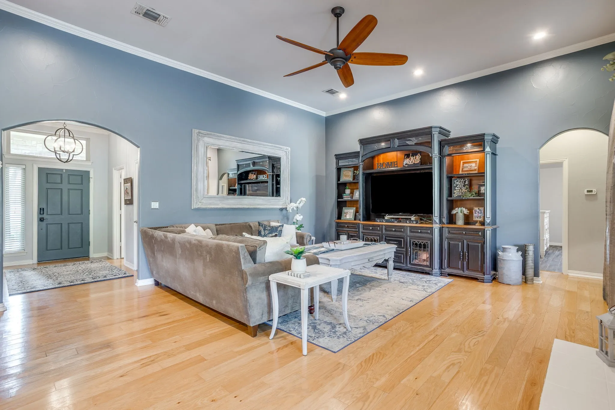 Hardwood flooring throughout, recessed lighting, and crown molding