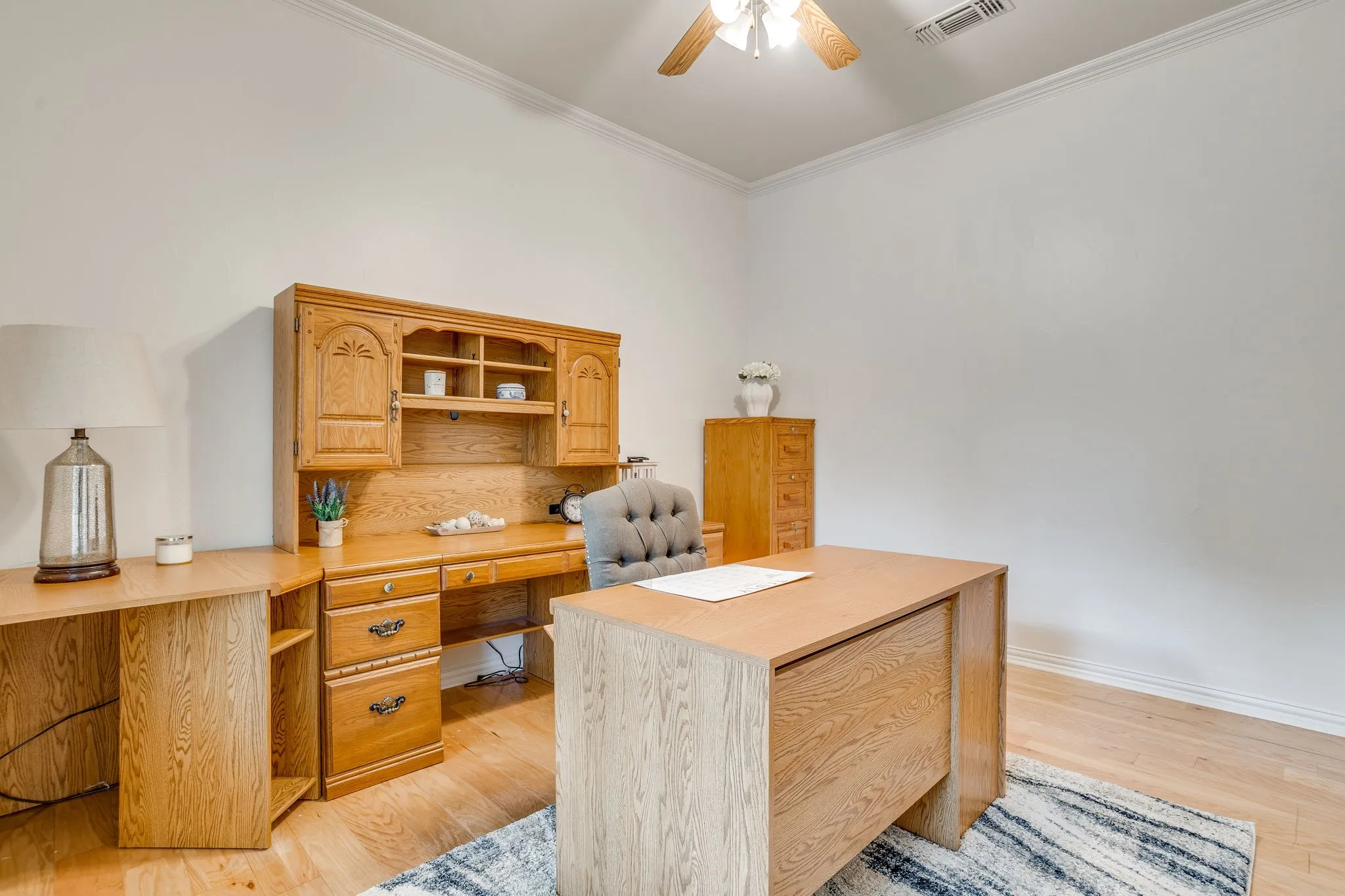 5th bedroom or offie with closet, Crown molding, wood-finish flooring, and a ceiling fan