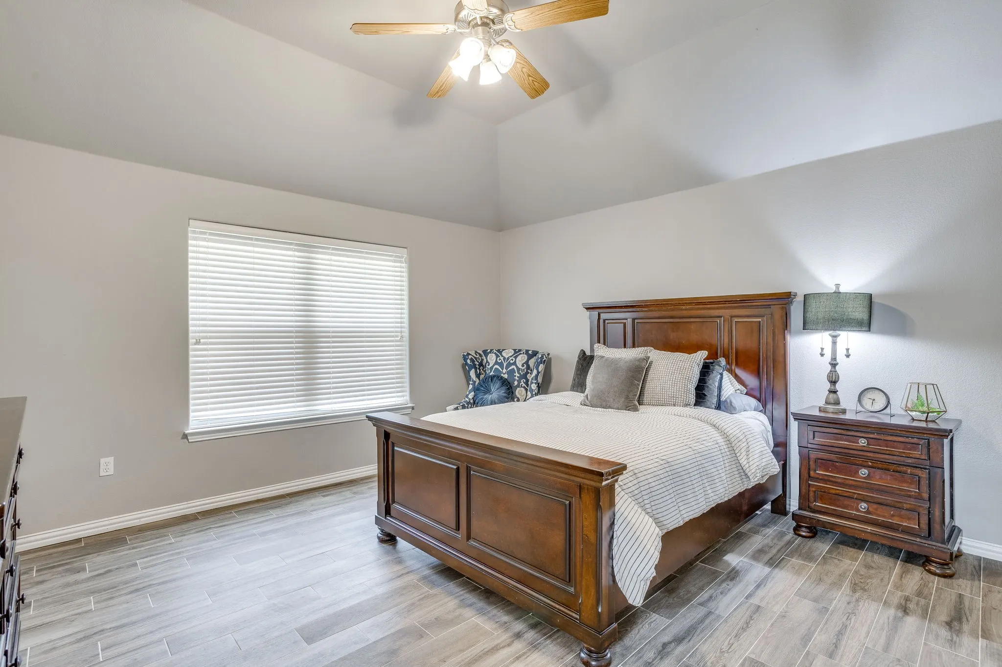 Bedroom 2 with full bath, Vaulted ceiling with a ceiling fan, window with blinds, and wood-finish flooring