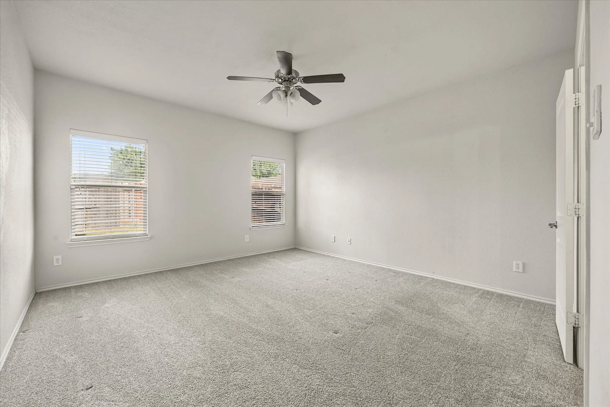 Primary bedroom with ceiling fan