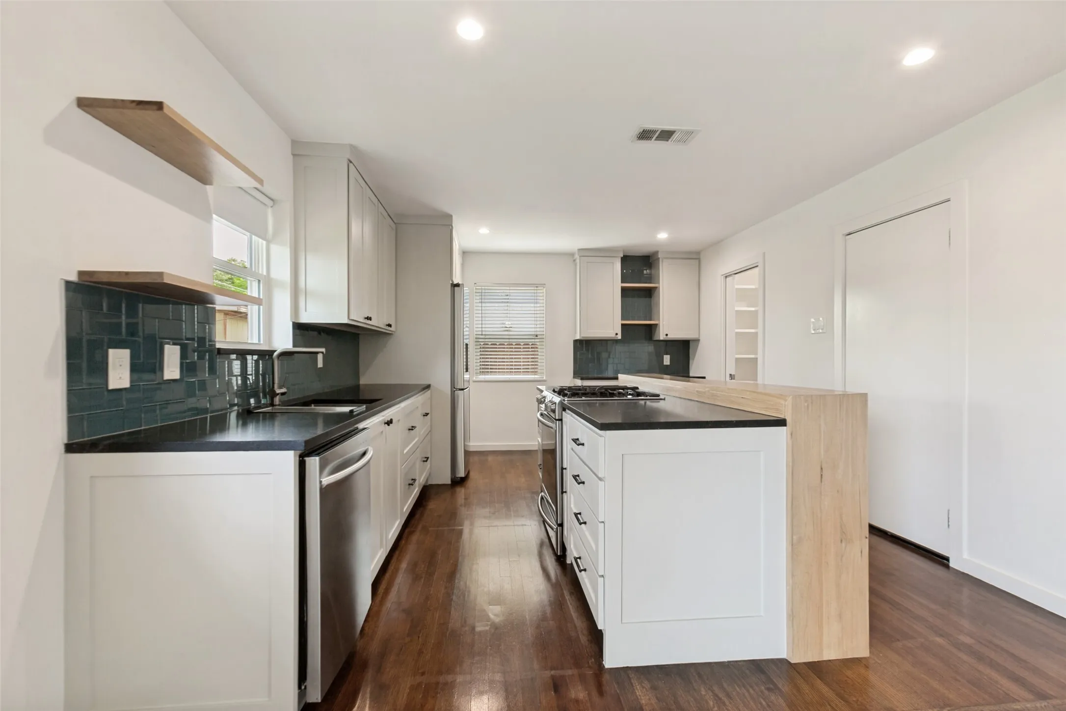Kitchen with stainless steel appliances and stone countertops