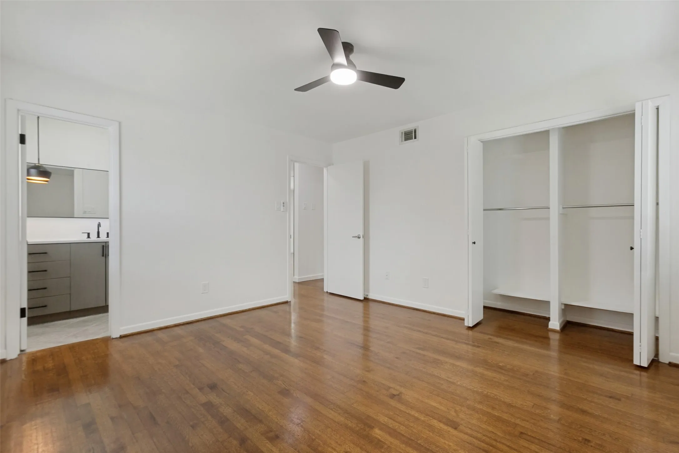 Primary Bedroom with view of ensuite bathroom and peek into the closet