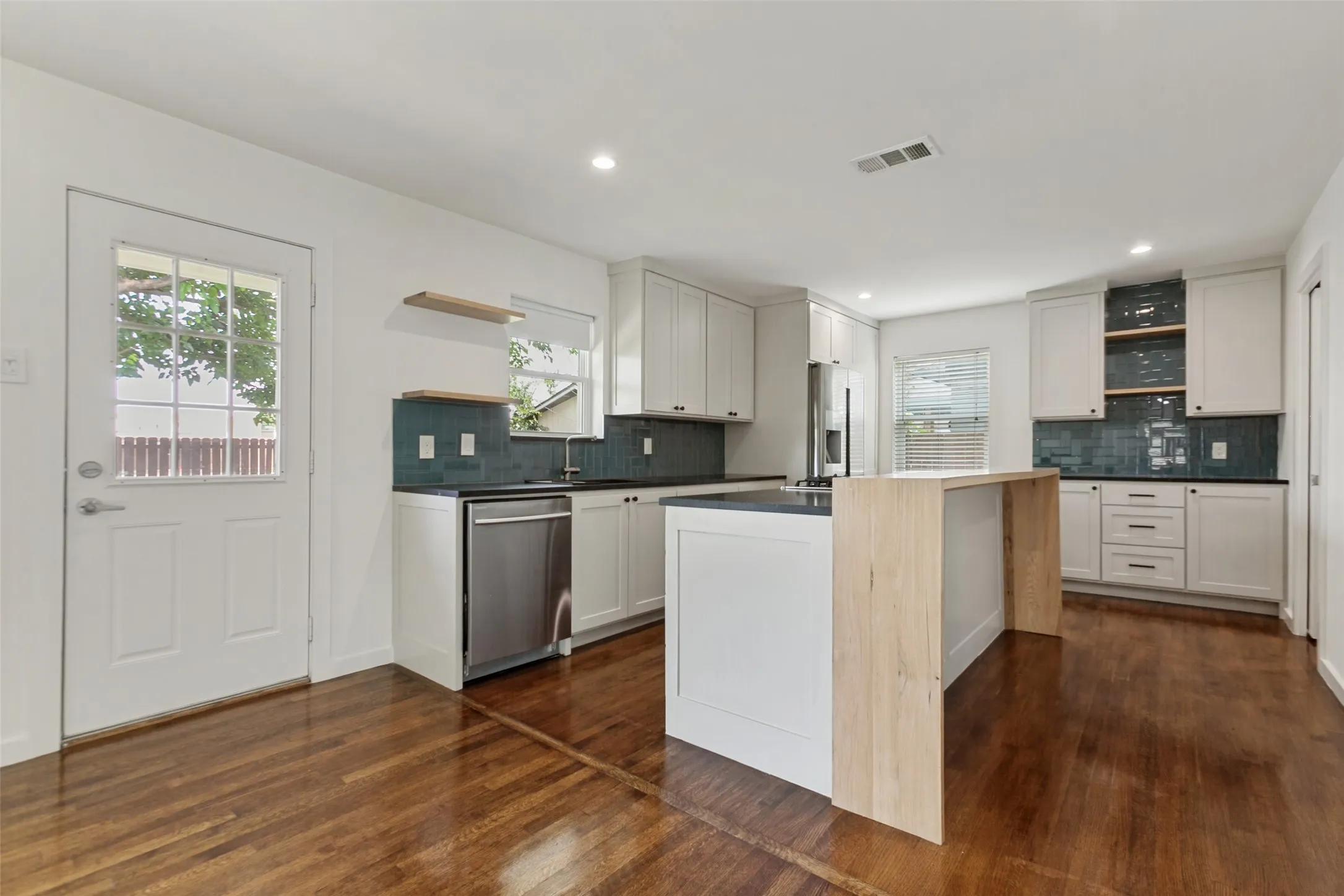 The kitchen with beautiful tile and cabinetry
