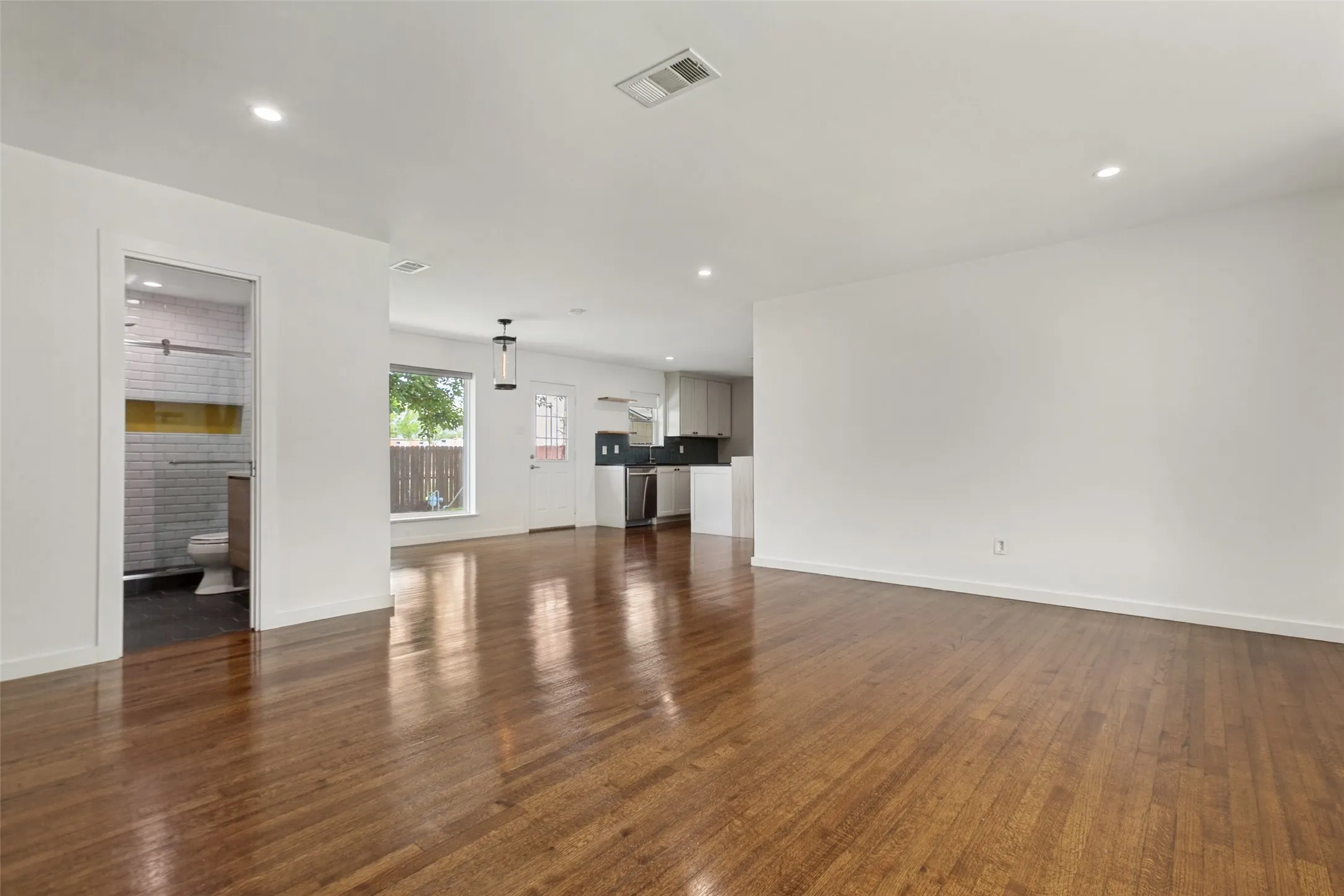 View of living, dining and kitchen from walking into the house