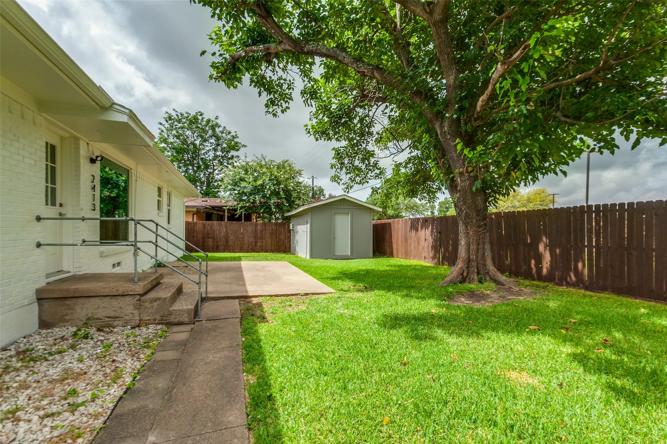 Backyard with shed for extra storage. Shed has electricity and portable a/c unit