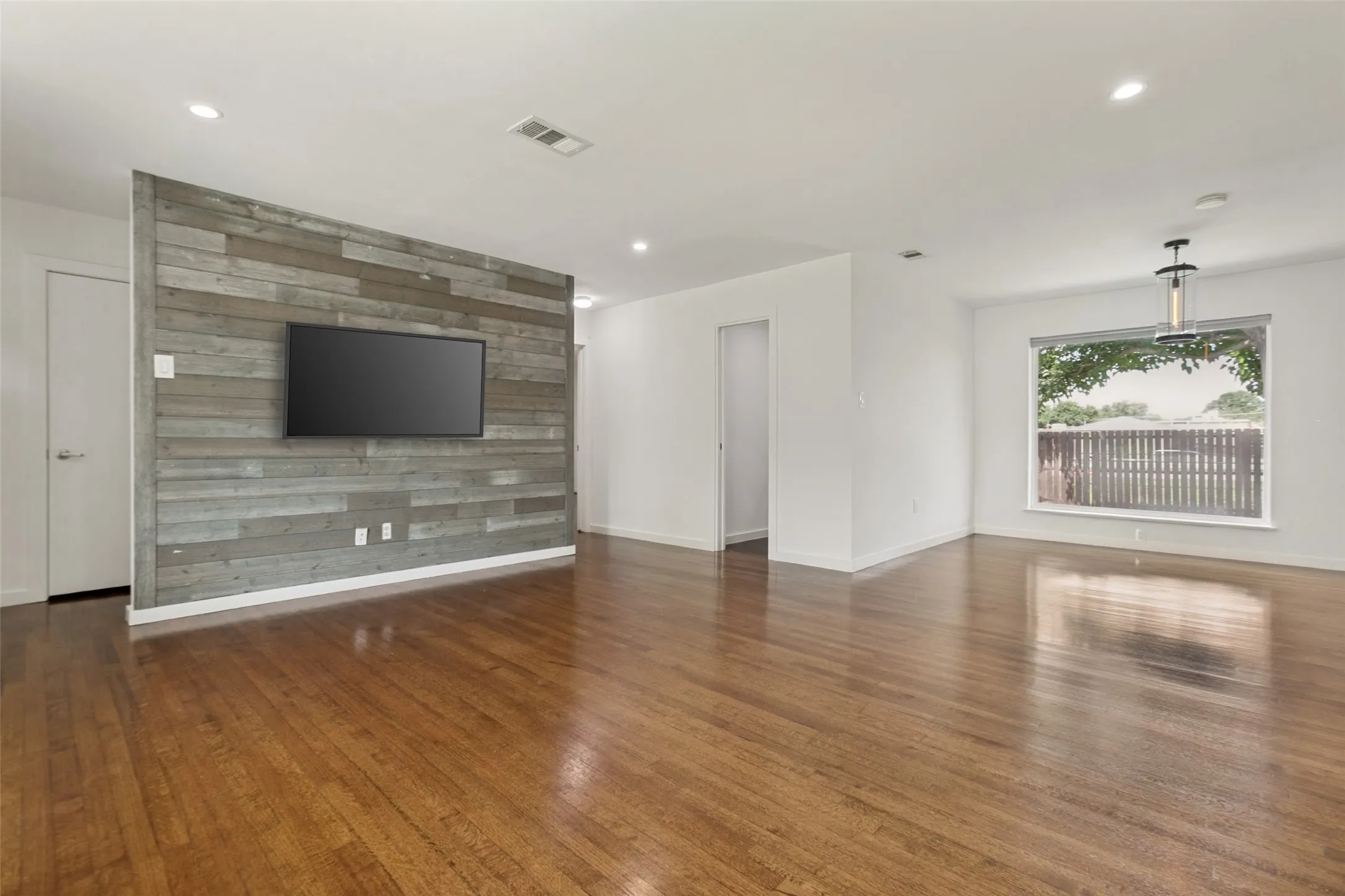 Living Room with views of the backyard, doorway leading to full bathroom