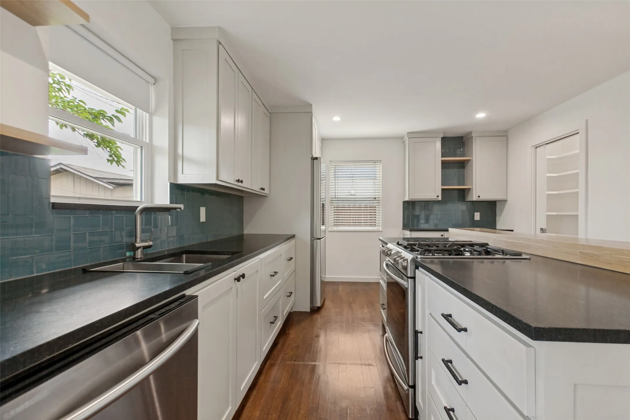 The kitchen is equipped with a gas range, and the island adds plenty of counter space